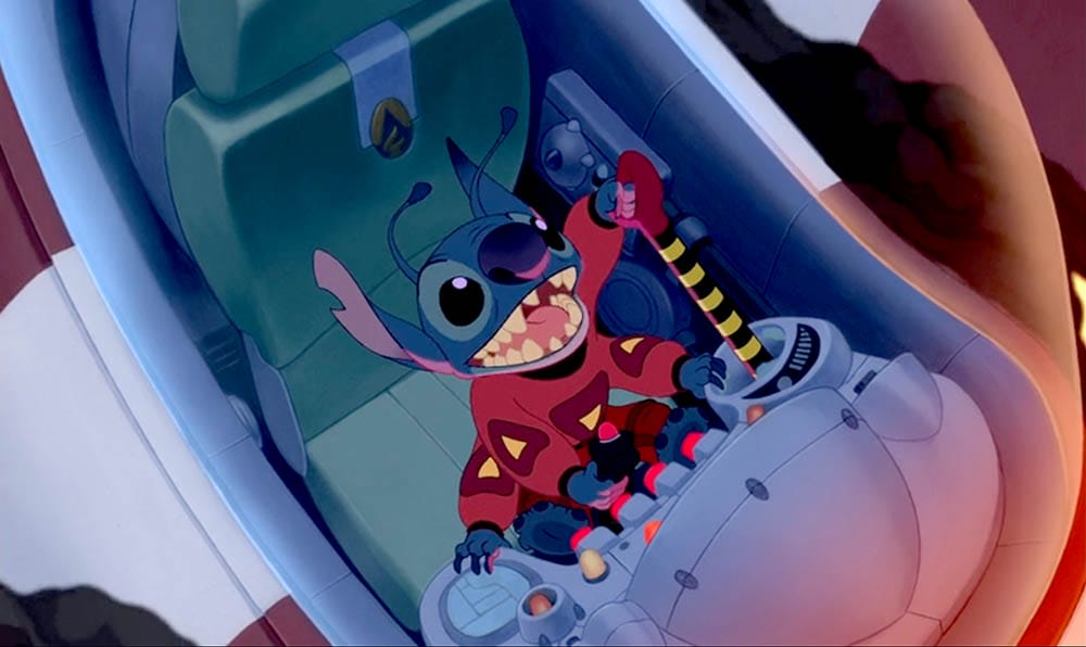 Blue alien Stitch, in a red suit, pilots a spaceship—perfect Stitch Wallpaper for fans. Free Downloads available!