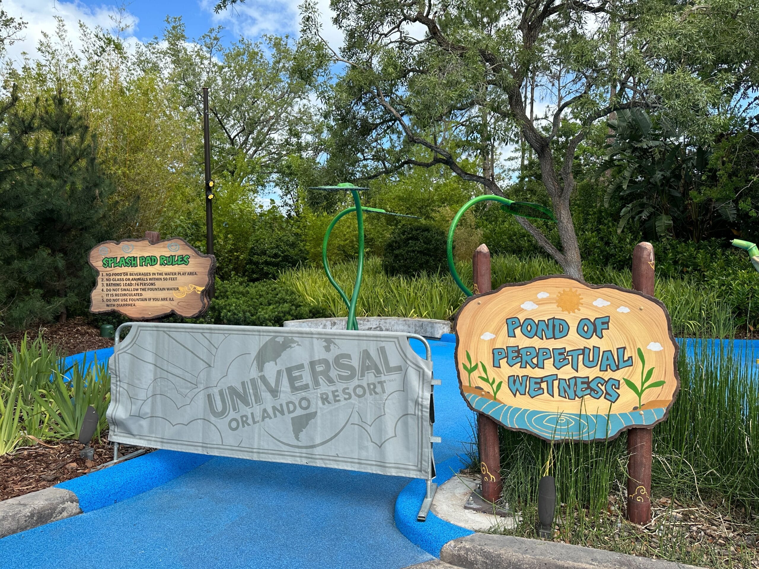 Entrance to "Pond of Perpetual Wetness" at Universal Orlando Resort, blocked by a temporary barricade.