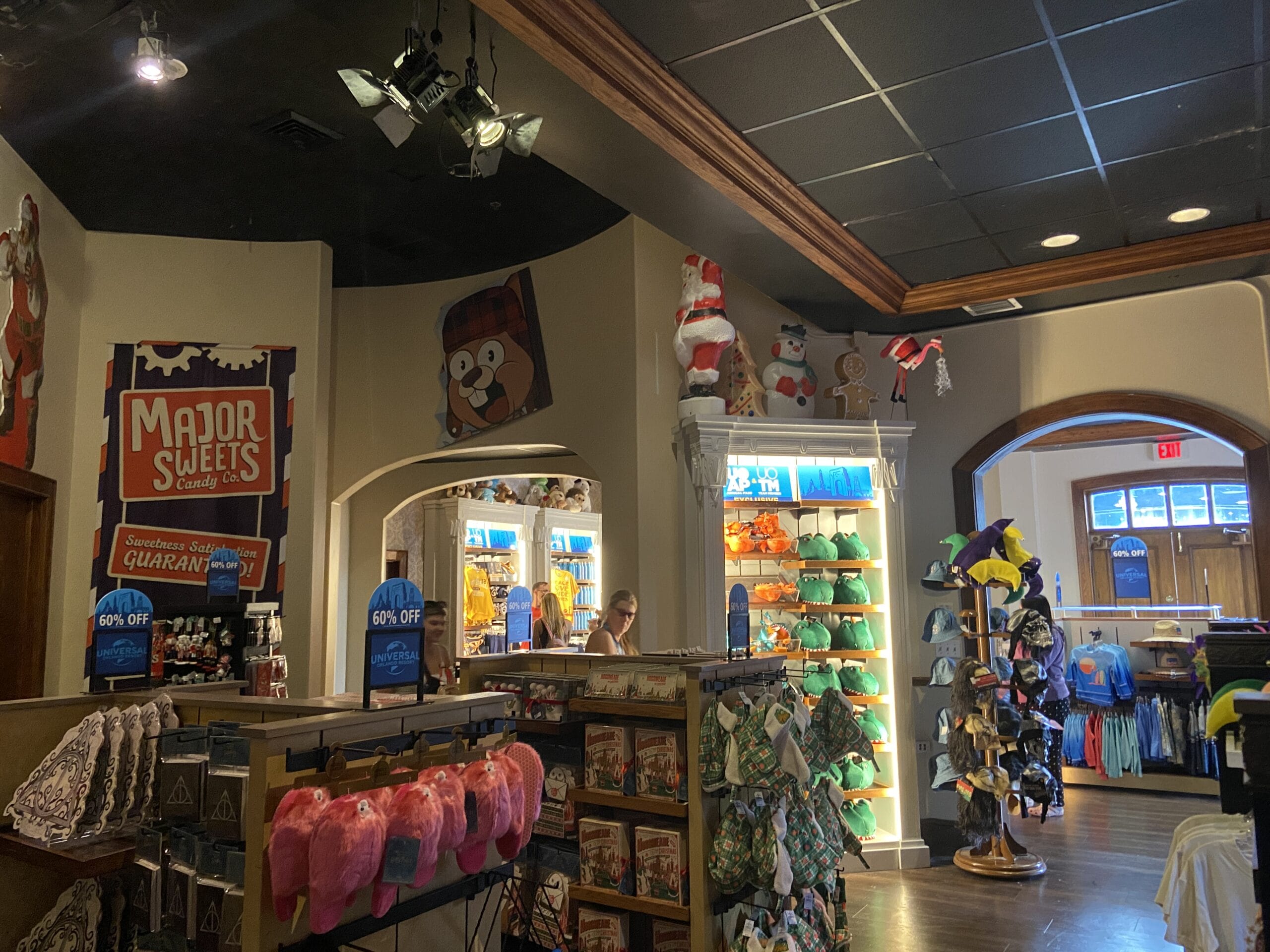 Gift shop interior with shelves of toys, clothing, candies; a Major Sweets sign and plush animals in the Summer Tribute Store.