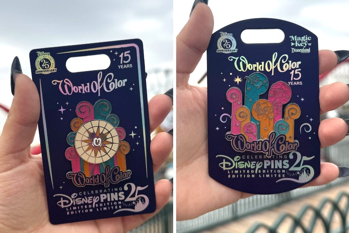 Two hands hold vibrant World of Color Anniversary Pins at Disney California Adventure against an outdoor backdrop.