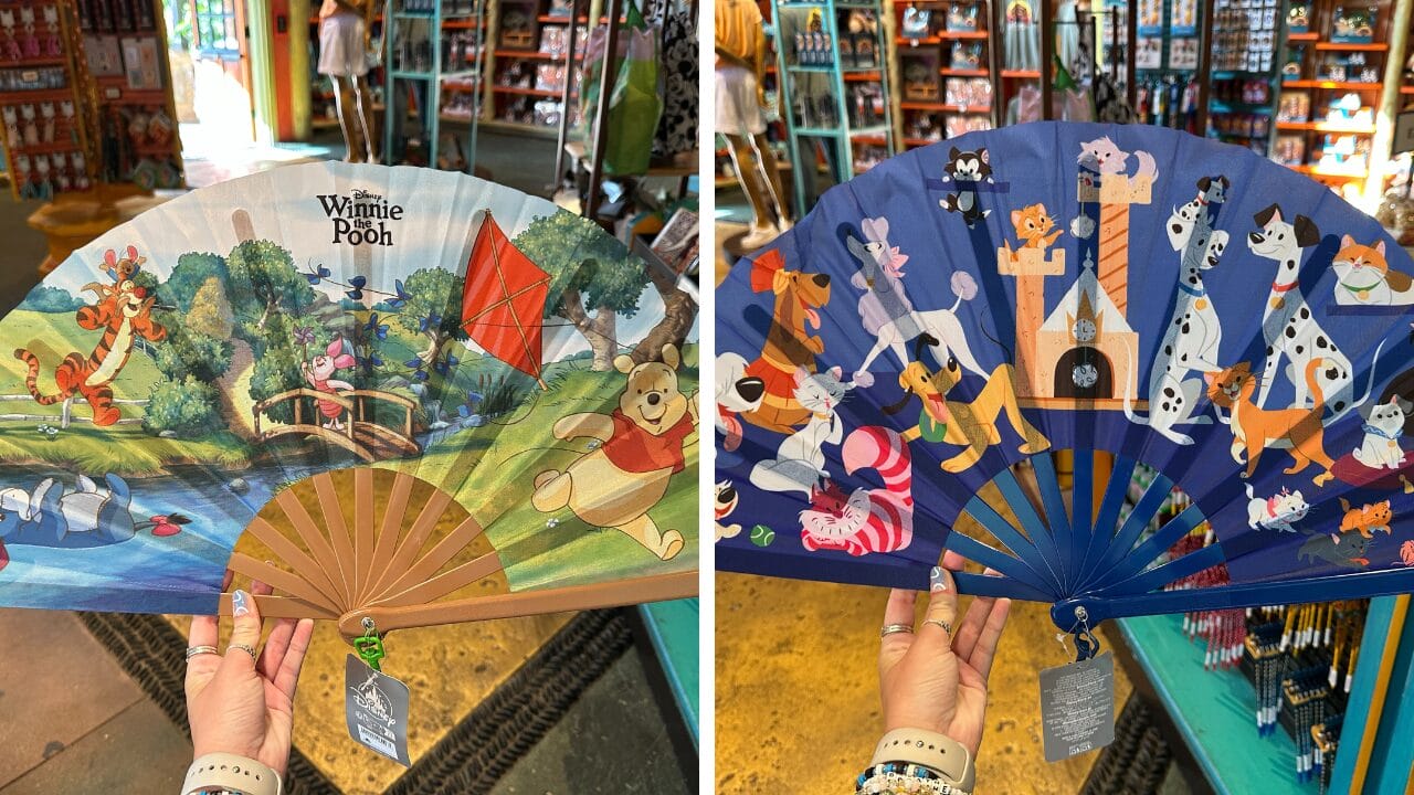 Two Hand Fans with Disney designs: Winnie the Pooh & friends on one, Disney animals on the other, shown in a store.