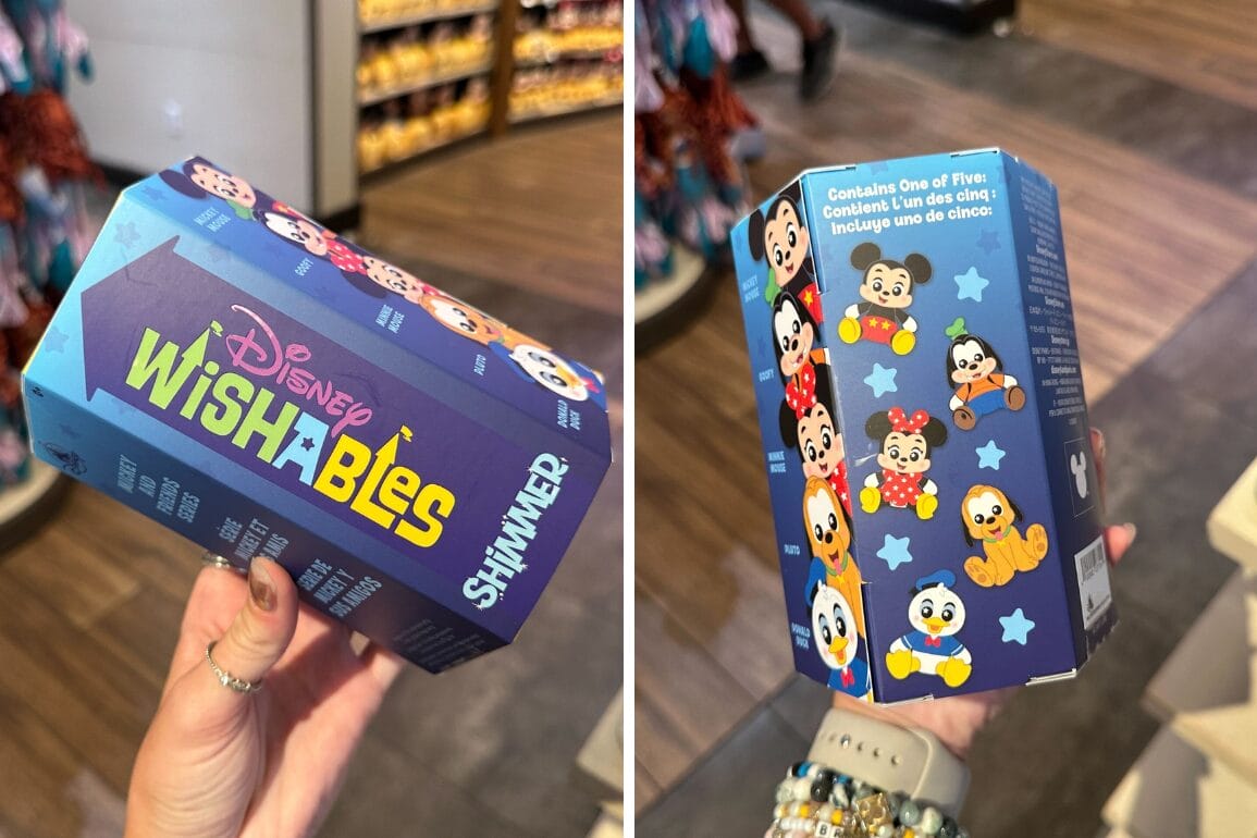 A hand holds a Disney Wishables Shimmer blind bag box featuring adorable wishables on a store floor.
