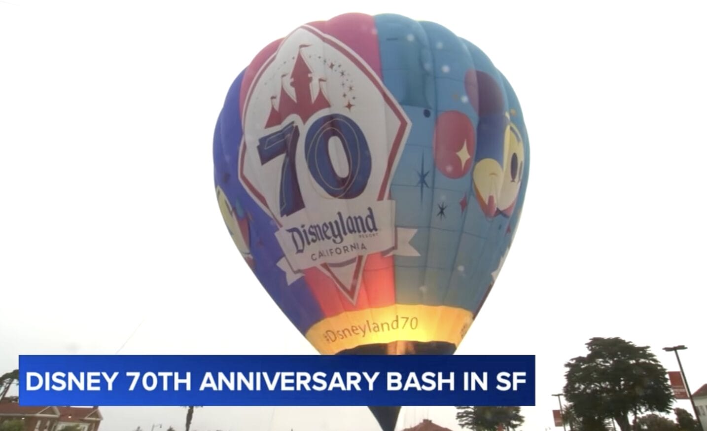 A vibrant hot air balloon with a "Disneyland 70th anniversary" logo shines at the San Francisco celebration.