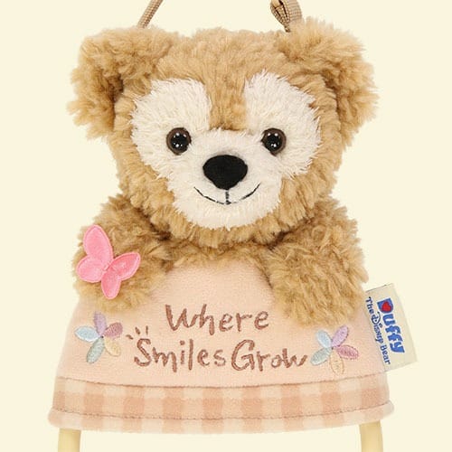 A plush Duffy the Disney Bear with a pink butterfly