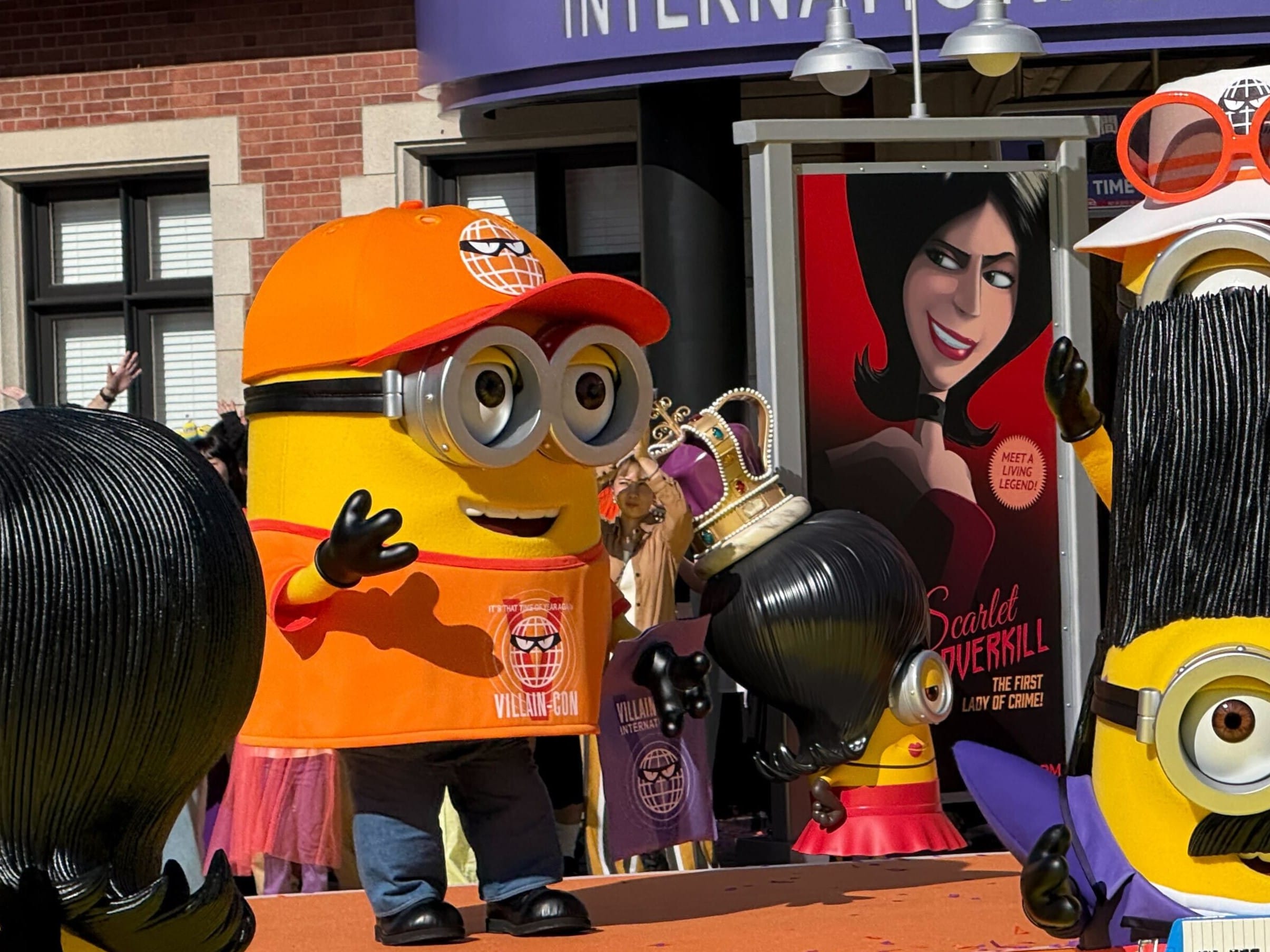 At the Minion Park Grand Opening Ceremony, a Minion in an orange cap stands beside another with a crown at Universal Studios Japan.