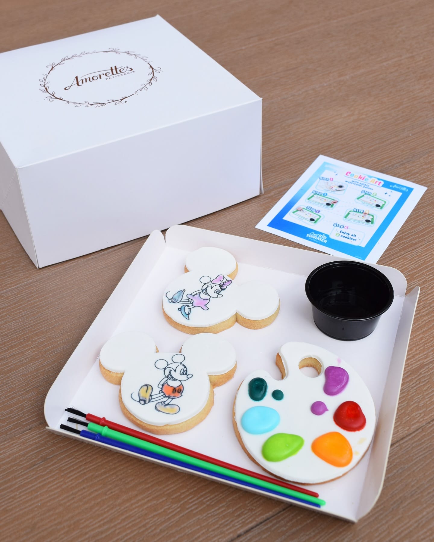 Decorate-your-own Walt Disney World cookie kit with Paint-Your-Own Cookies, edible palette, brushes, and a white Amorette's box.