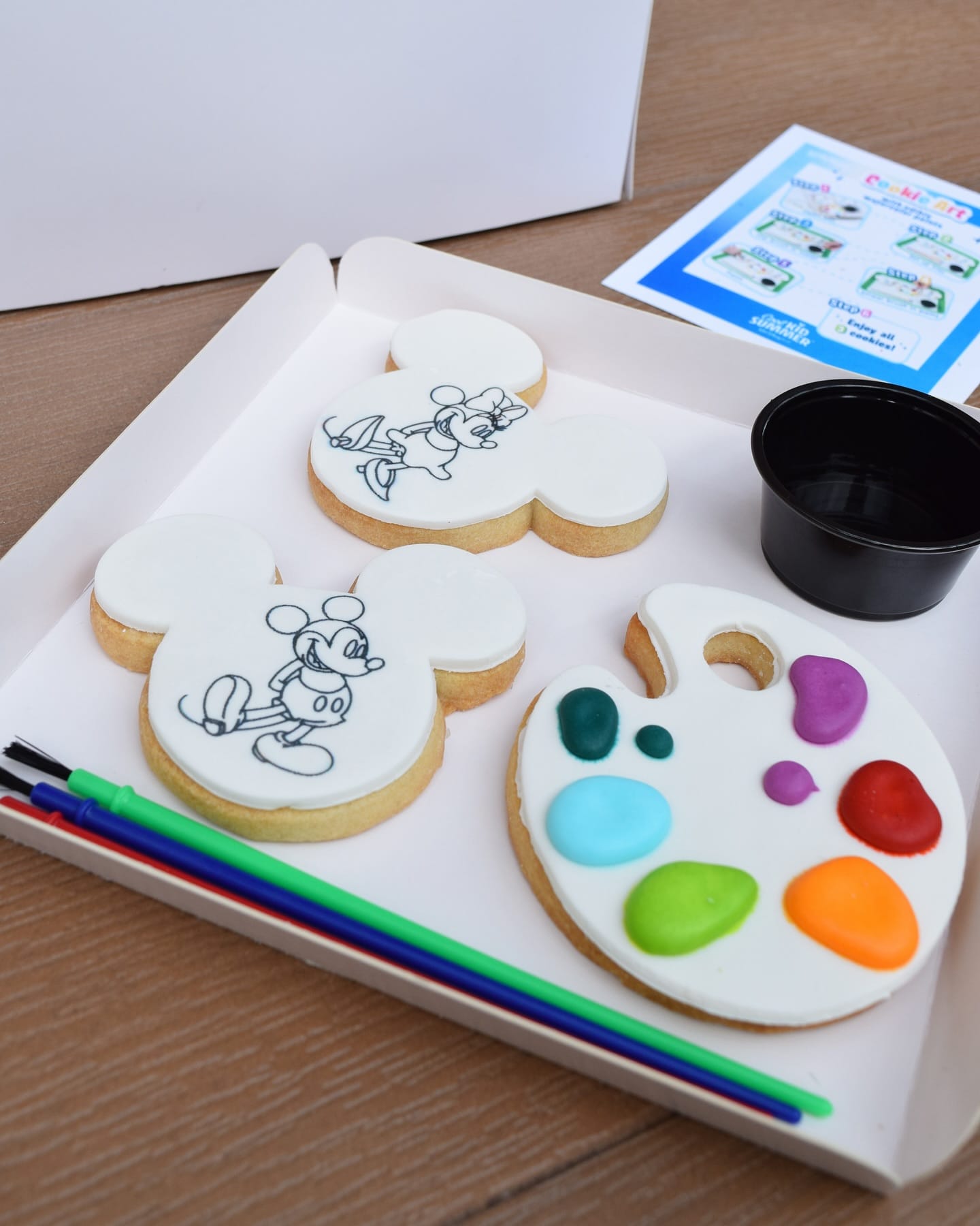 Paint-Your-Own Cookies shaped like Mickey Mouse and a paint palette on a tray, inspired by Walt Disney World.