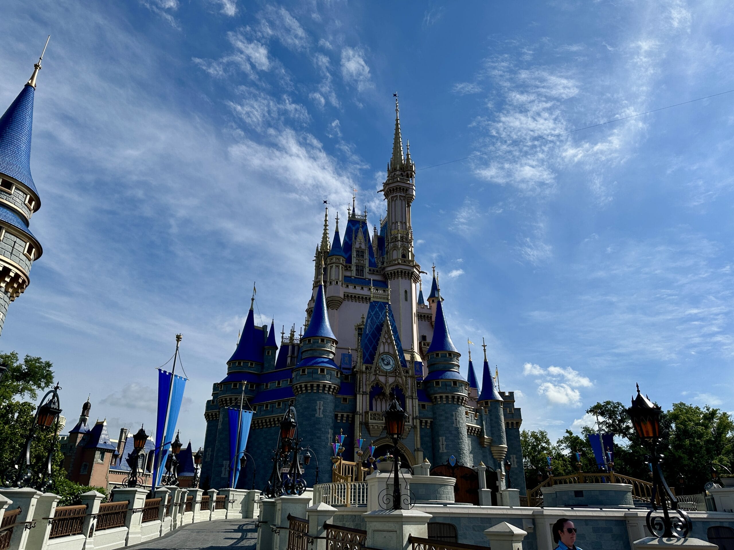 Cinderella Castle at Magic Kingdom under a sunny blue sky, with turrets and flags—perfect for a T-Shirt Design.