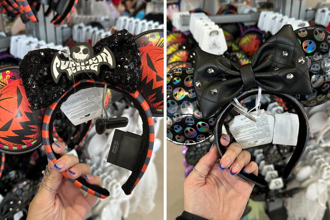 Two hands hold Nightmare Before Christmas Loungefly Ear Headbands with Pumpkin King designs in a store display.