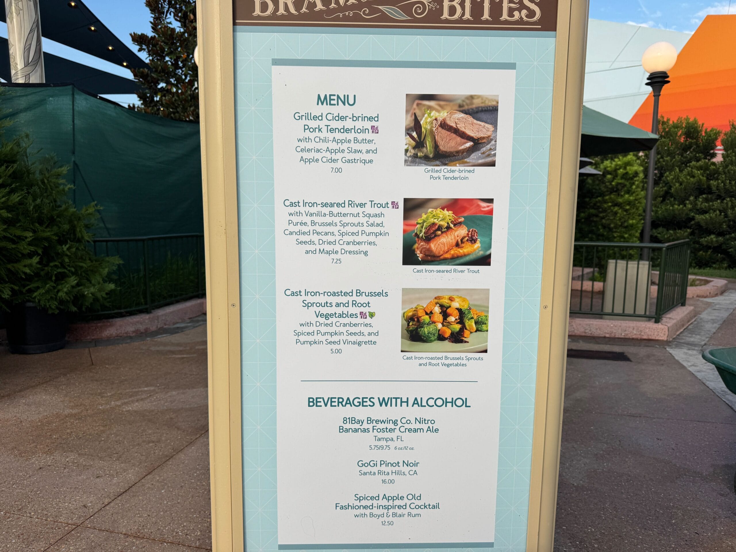 Menu board displaying Food & Wine options, featuring pork tenderloin, river trout, and brussels sprouts.