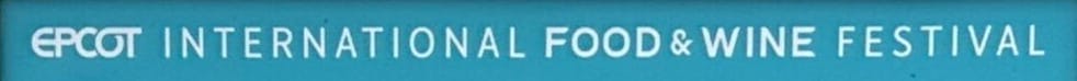 Sign featuring the EPCOT International Food & Wine Festival displayed on a striking blue background.