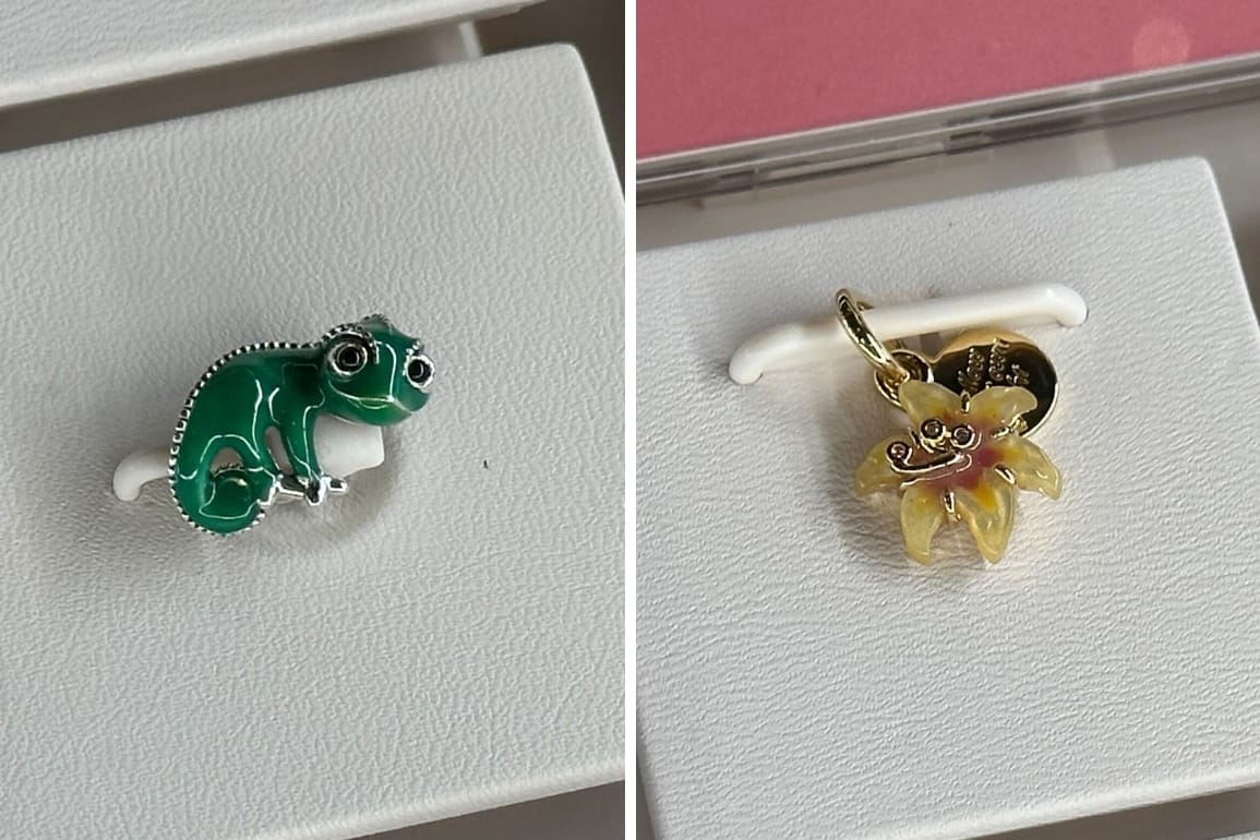 Two charms from the Pandora Tangled collection: a green Pascal chameleon charm and a yellow sundrop flower charm.