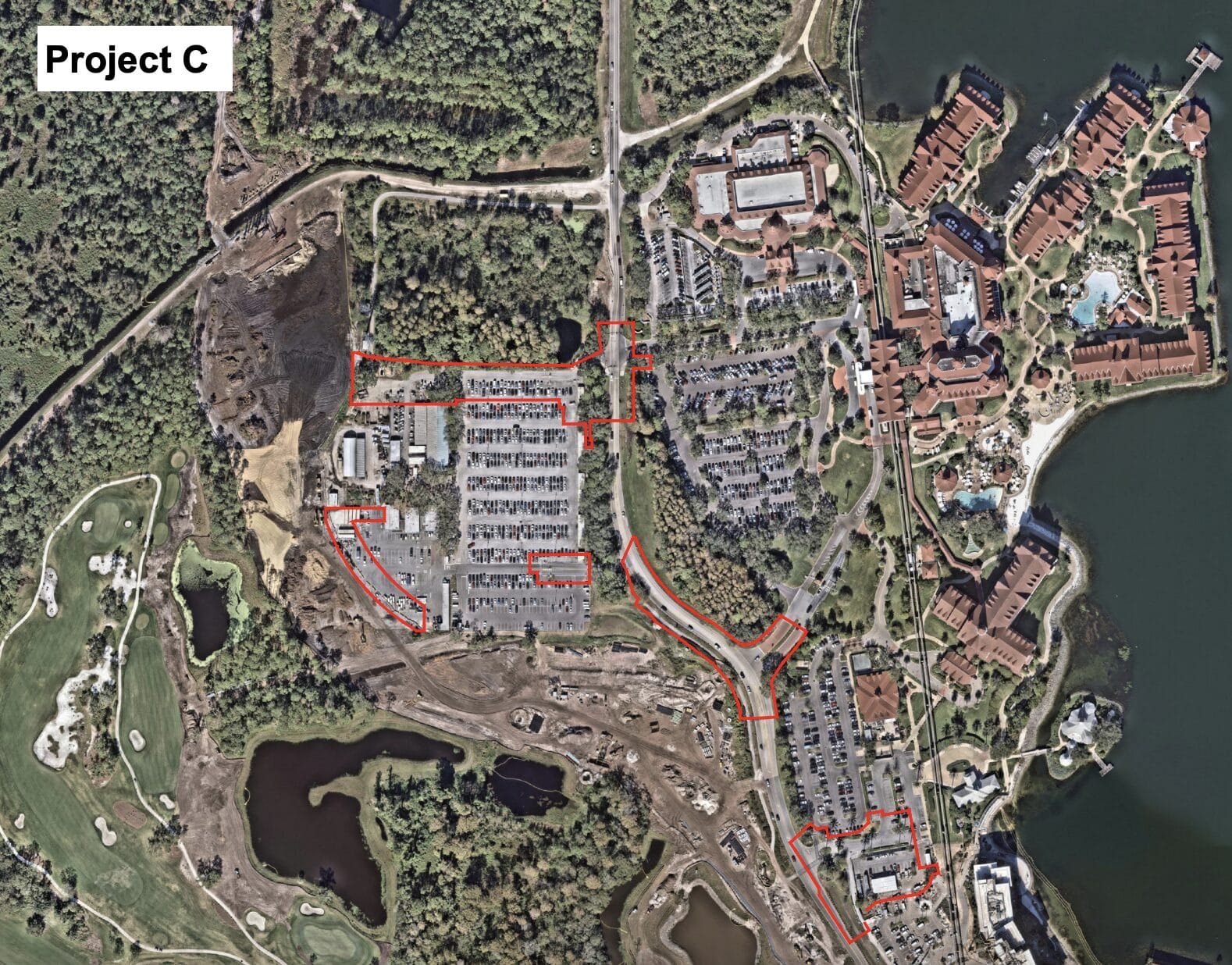 Aerial view of a construction site with parking lots and buildings outlined in red, labeled "Project C" in upper left.