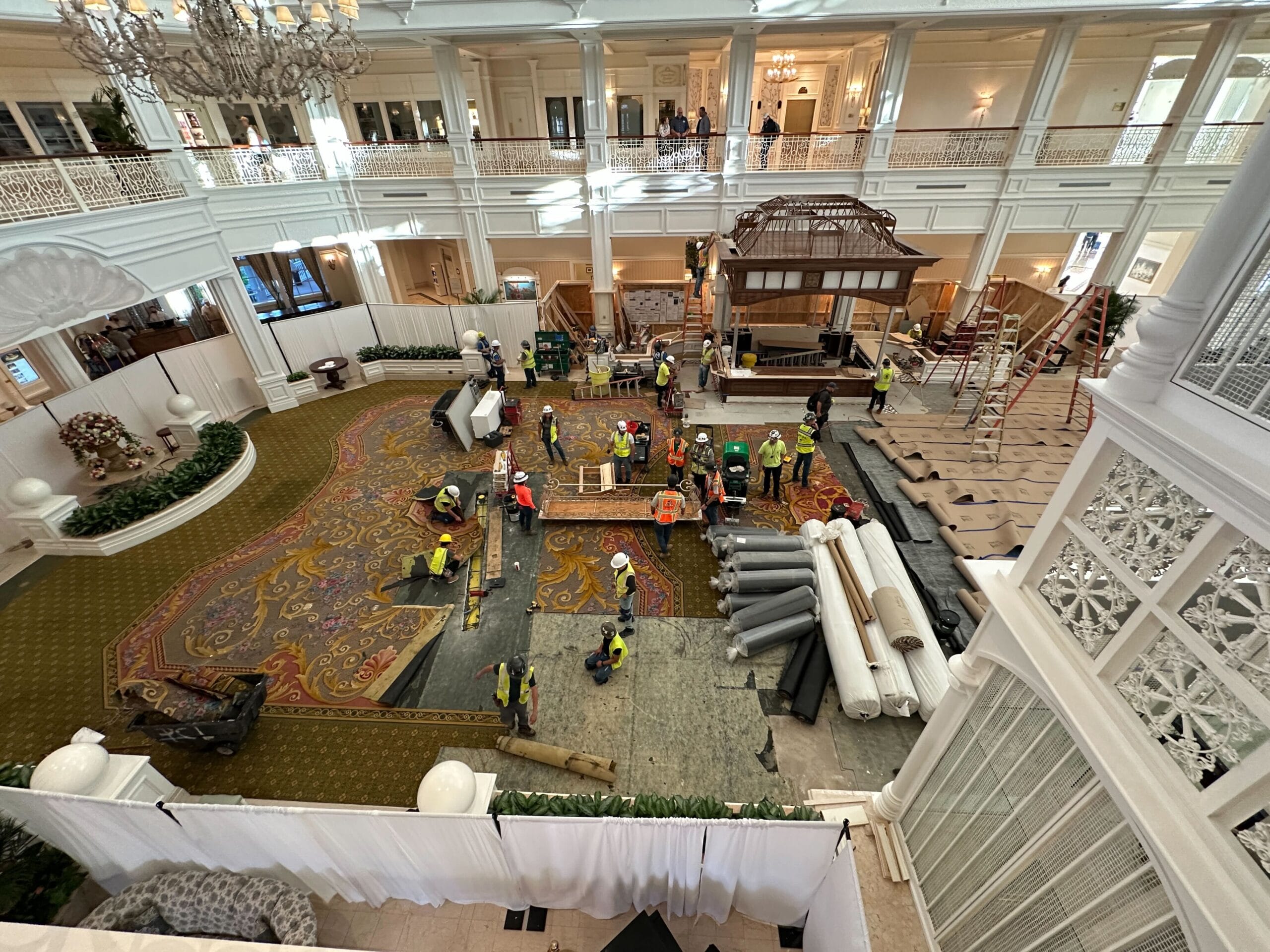 Workers lay new flooring in the luminous Grand Floridian Lobby, echoing the elegance found in Disney’s park castles worldwide.