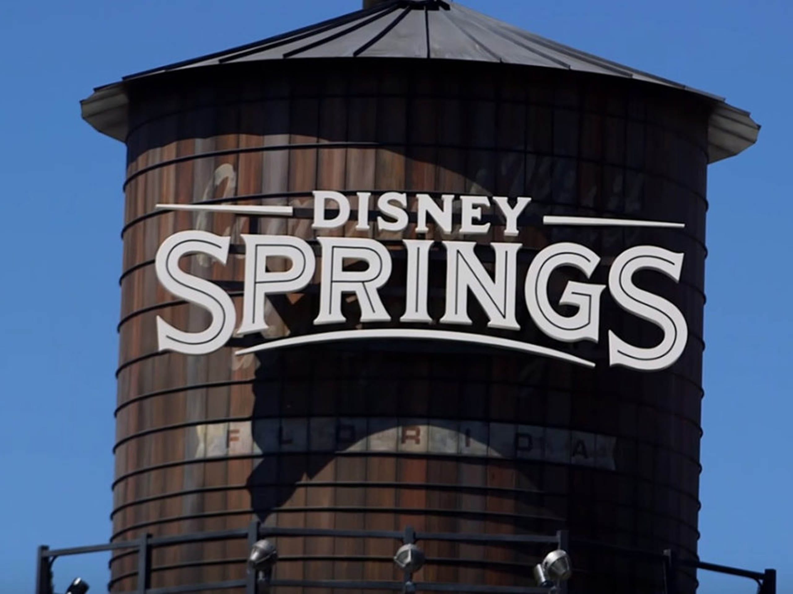 A Disney Springs water tower at Walt Disney World stands tall beneath a blue sky, an icon distinct from any Disney castle worldwide.