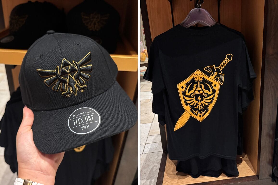 A black hat and t-shirt with gold Zelda Apparel designs, featuring the Hylian Crest and Master Sword.