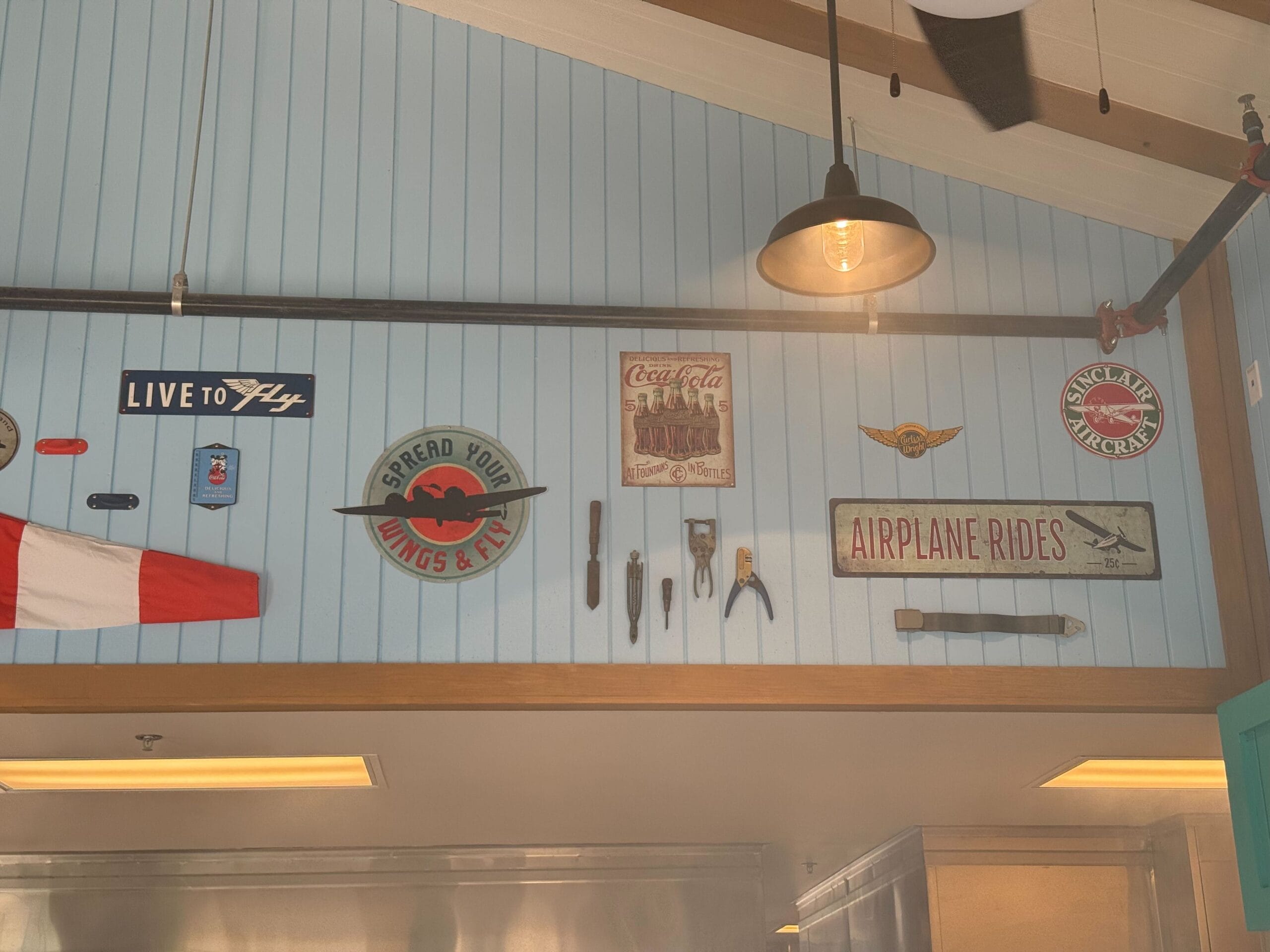 In addition to more metal signs and a wood propeller, the interior has smaller props like tools and a seatbelt.