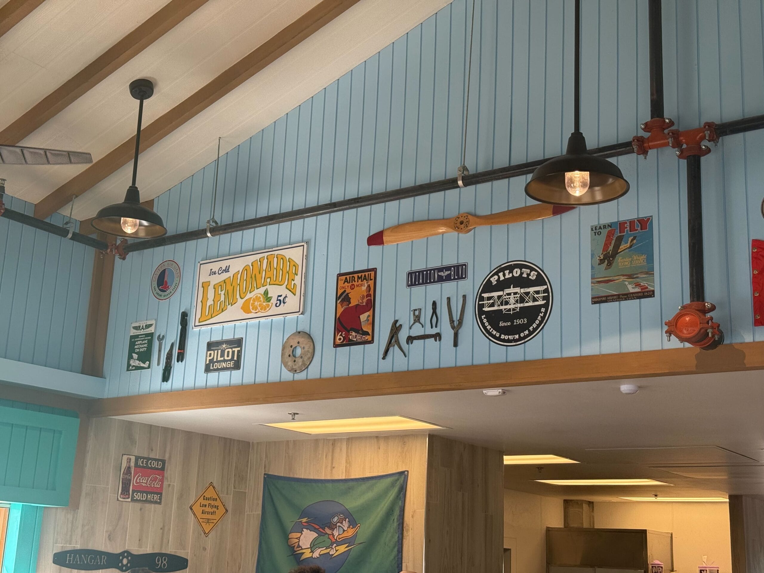 In addition to more metal signs and a wood propeller, the interior has smaller props like tools and a seatbelt.