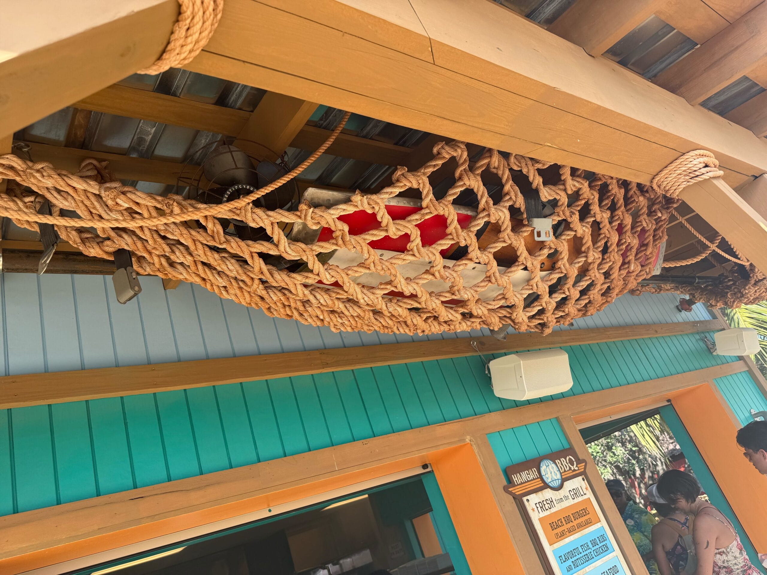 More props and a fan are in a fishing net hanging in front of the doors.