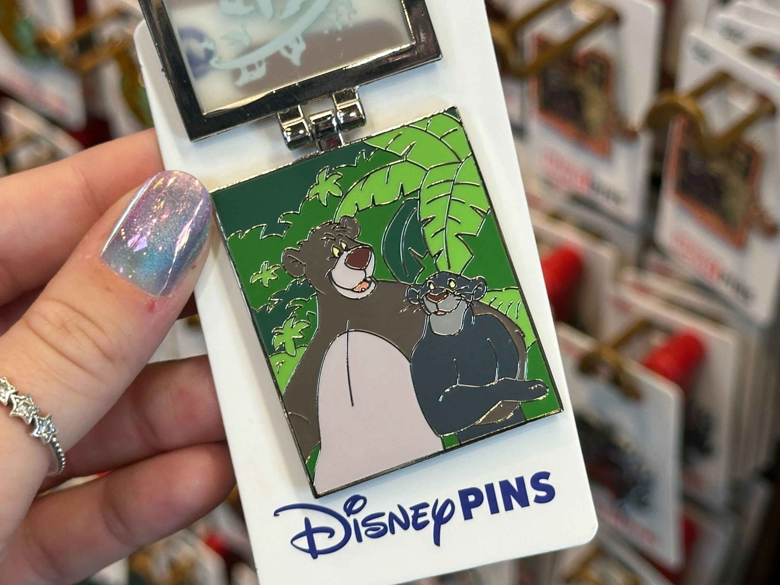 This new open edition pin features the Disney Conservation Fund logo.