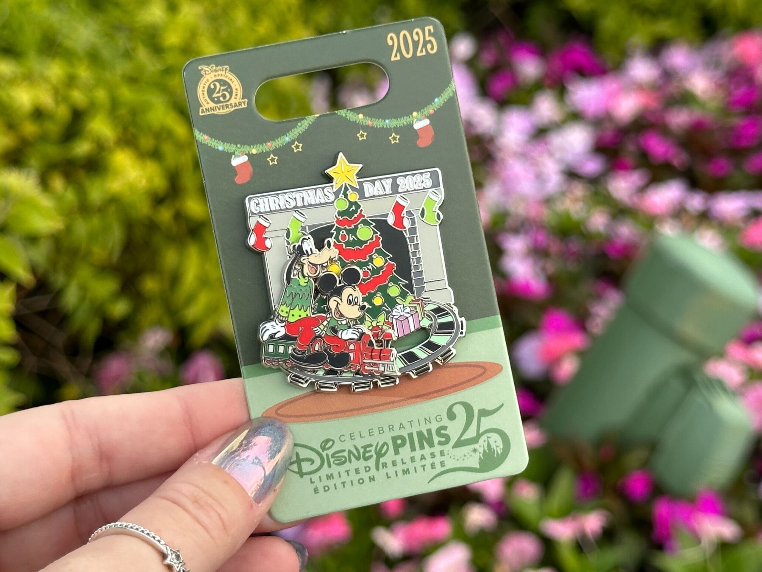 The Christmas Day 2025 pin features Goofy and Mickey riding a train around a Christmas tree.