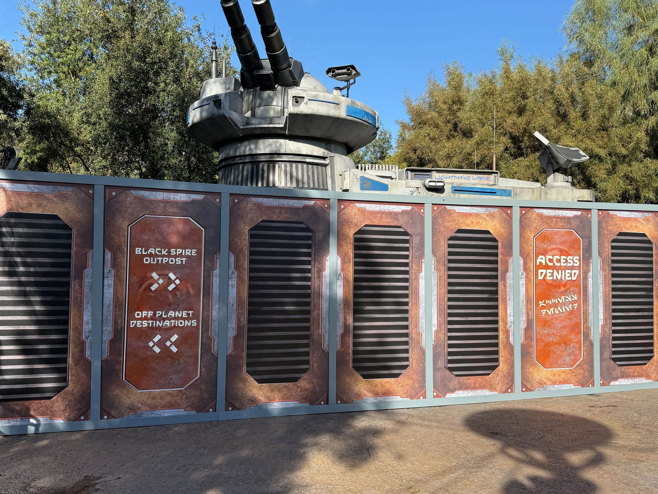Various themed signs that read "Access Denied" block the access points to the attraction. Green scrim also surrounds the area.