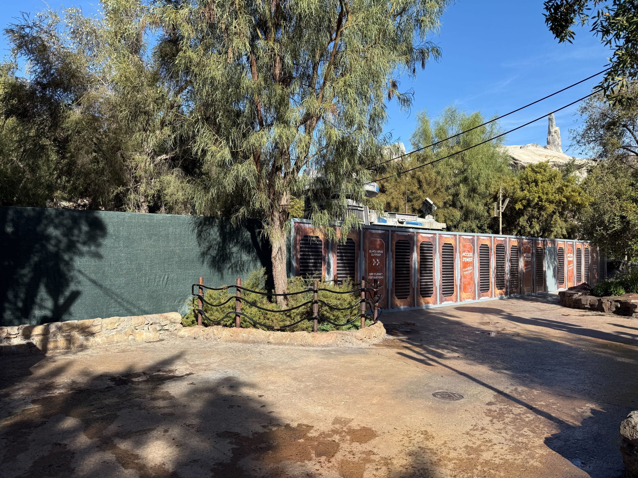 Various themed signs that read "Access Denied" block the access points to the attraction. Green scrim also surrounds the area.