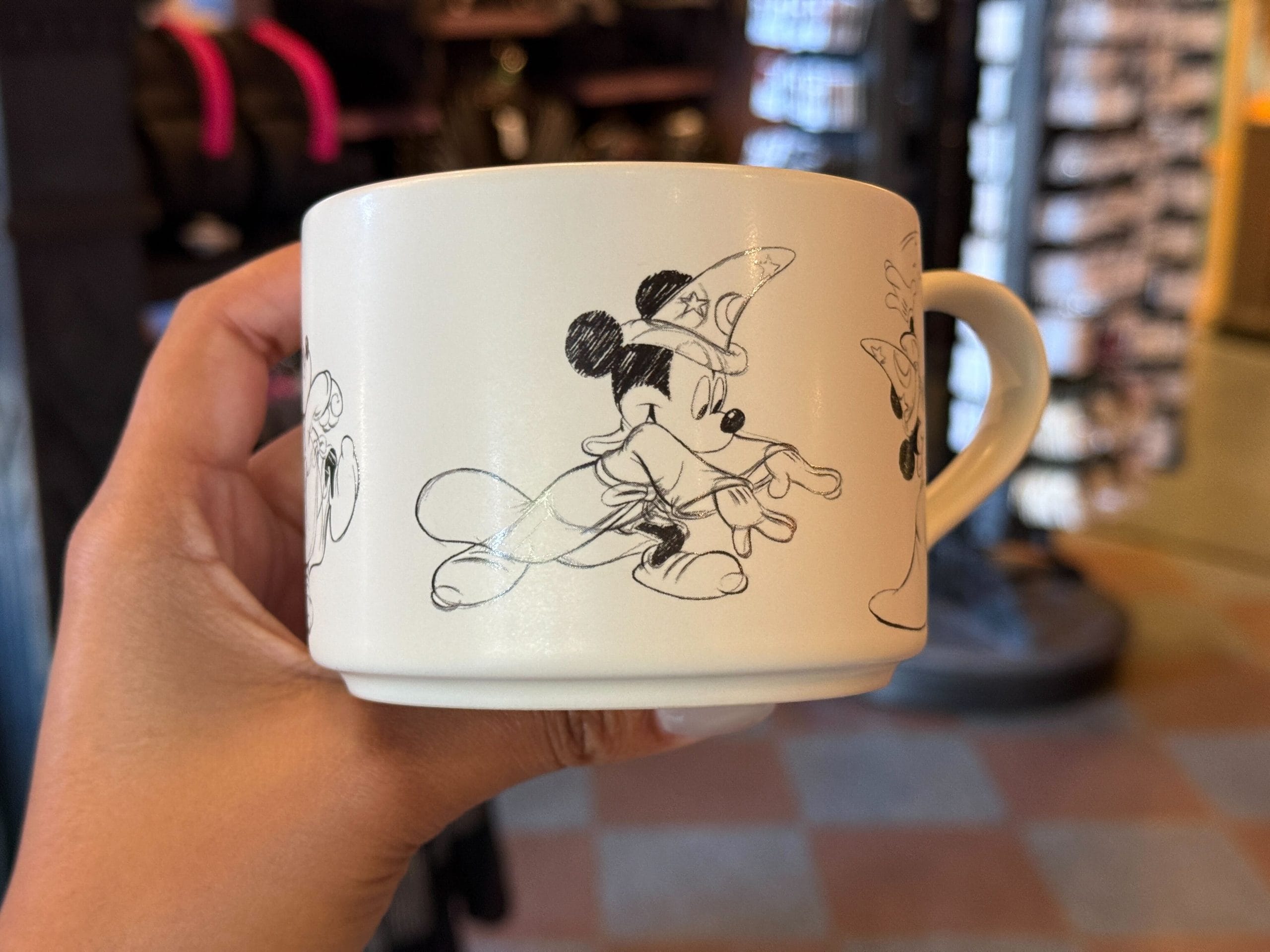 The Mickey sketches depict him putting on the sorcerer’s hat and casting magic. The interior is gloss blue.