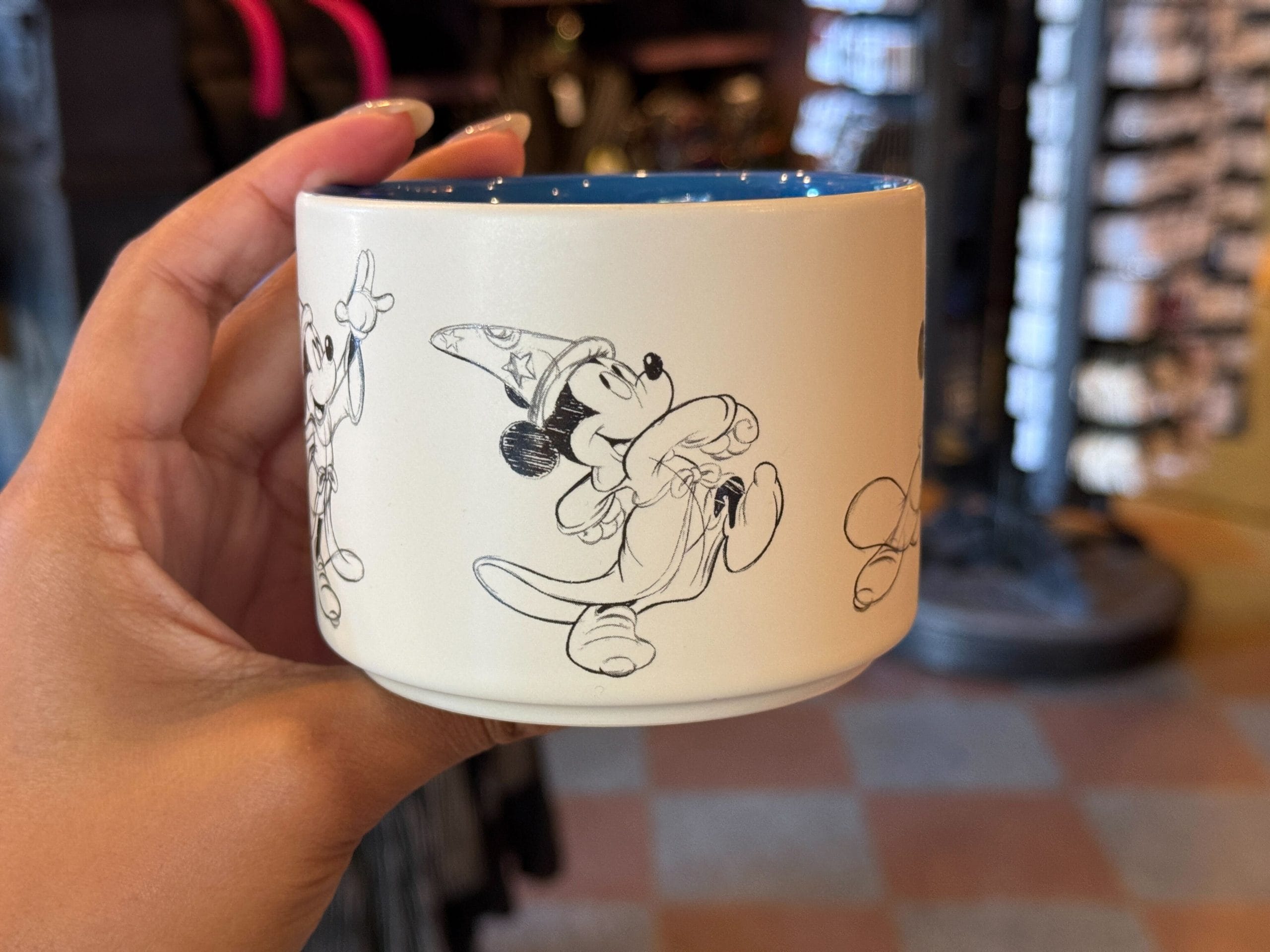 The Mickey sketches depict him putting on the sorcerer’s hat and casting magic. The interior is gloss blue.