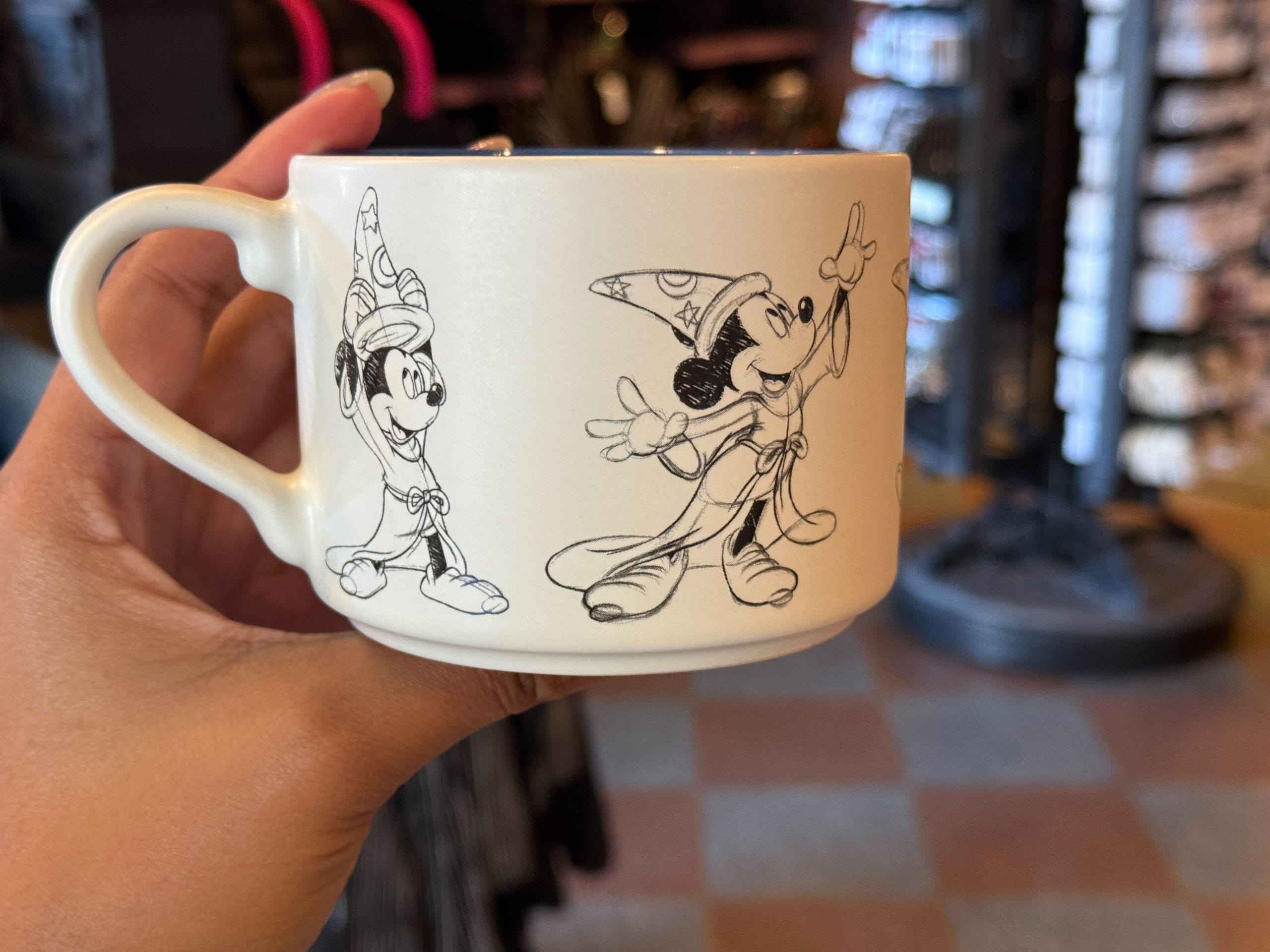 The Mickey sketches depict him putting on the sorcerer’s hat and casting magic. The interior is gloss blue.