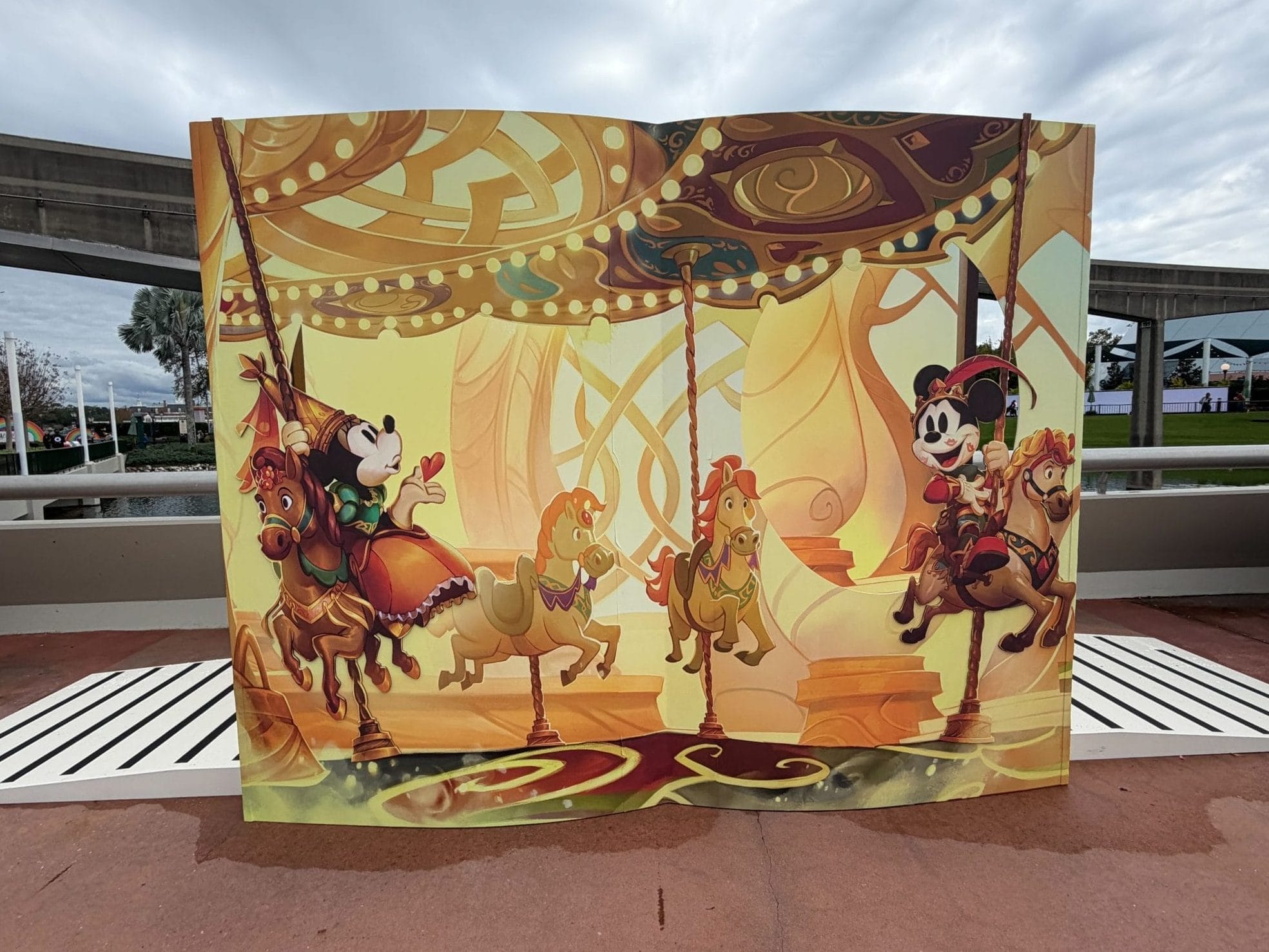 Guests can pose with card art from the Disney Lorcana set, Fabled at the EPCOT Festival of the Arts.