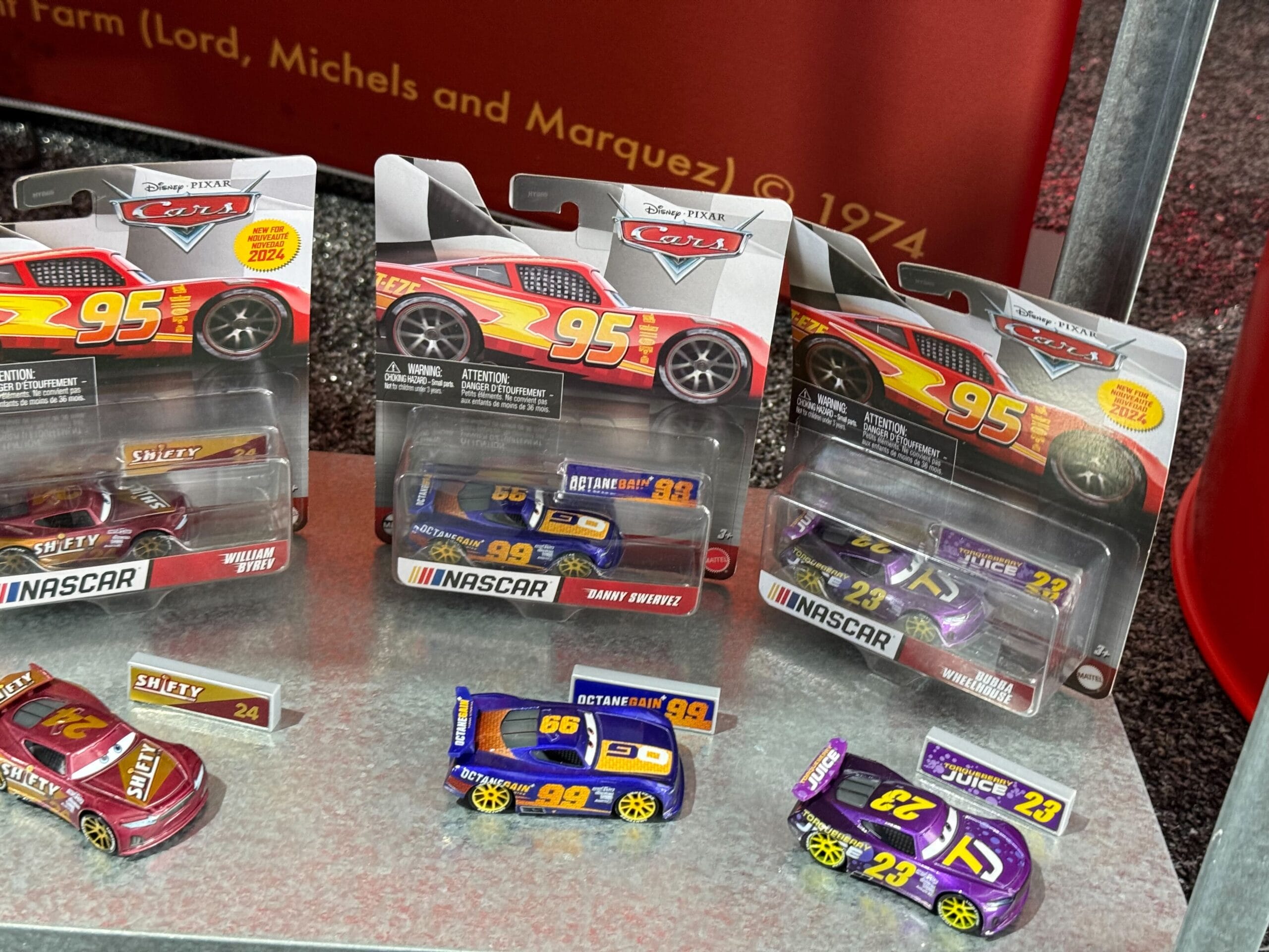 Display of Cars 20th Anniversary merchandise at Daytona 500 2026