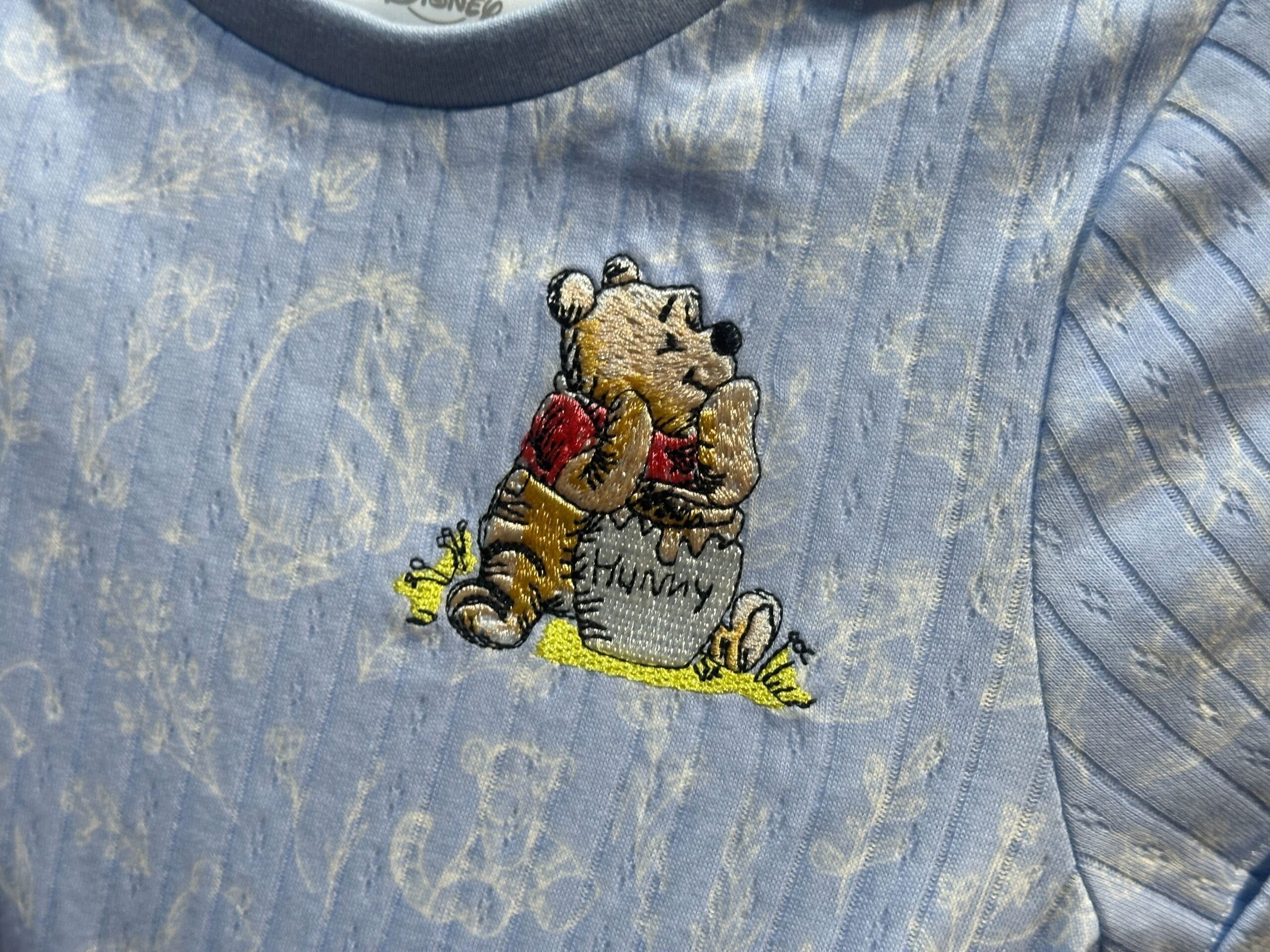 Close up of embroidery on the youth Winnie the Pooh dress.