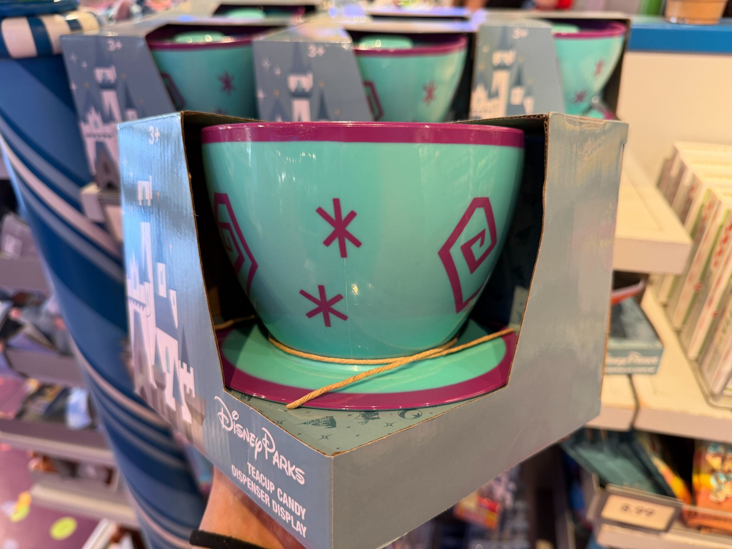 The swirls and stars on the side of the cup, similar to the ride vehicles on Mad Tea Party, are purple. Pez dispensers and candy are not included with this holder.