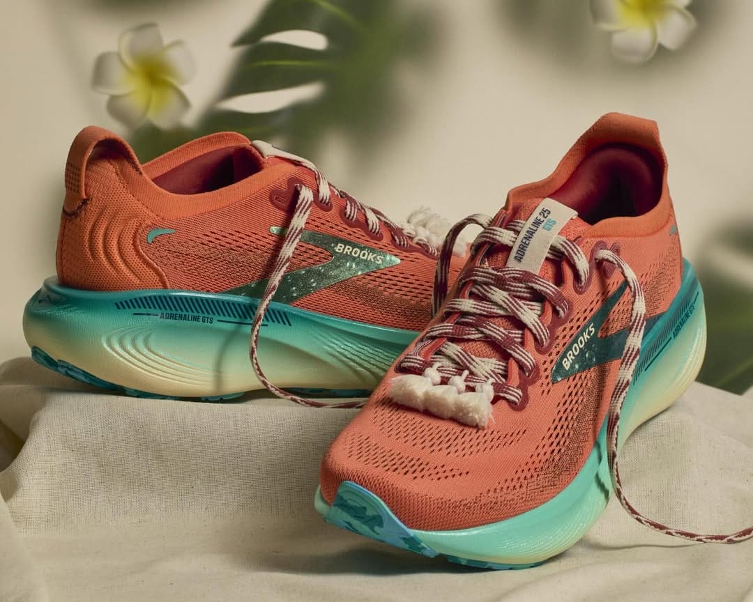 The Moana shoes come in an orange body with a bottom in a blue to white gradient. White tassels hang from the bottom of the laced front, and the dual-sided laces are white with red stripes or red with white stripes on the other side.