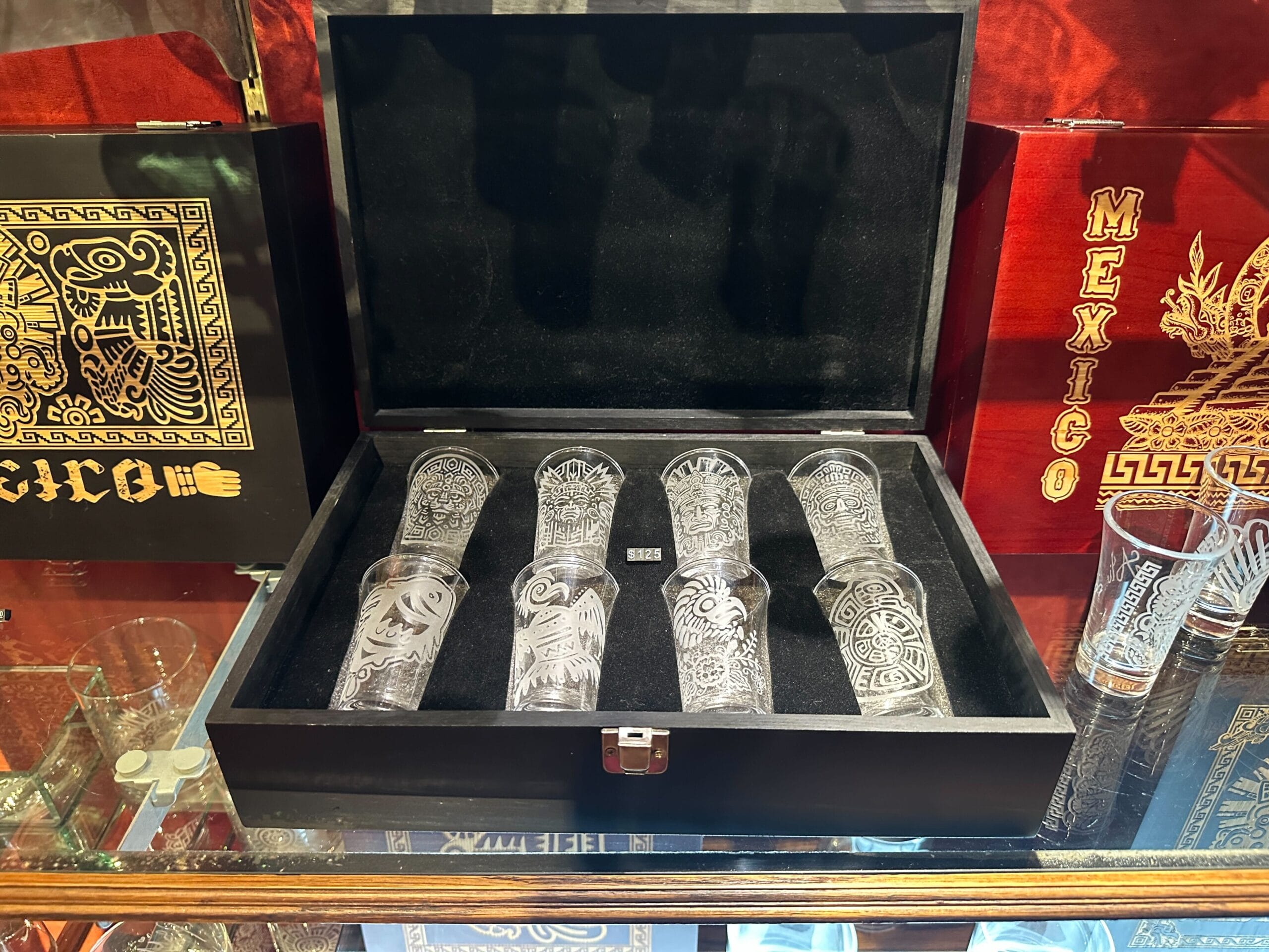 An eight-piece shot glass set in a decorative wood box is also now available at the pavilion. Each of the shot glasses features a different Mesoamerican symbol.