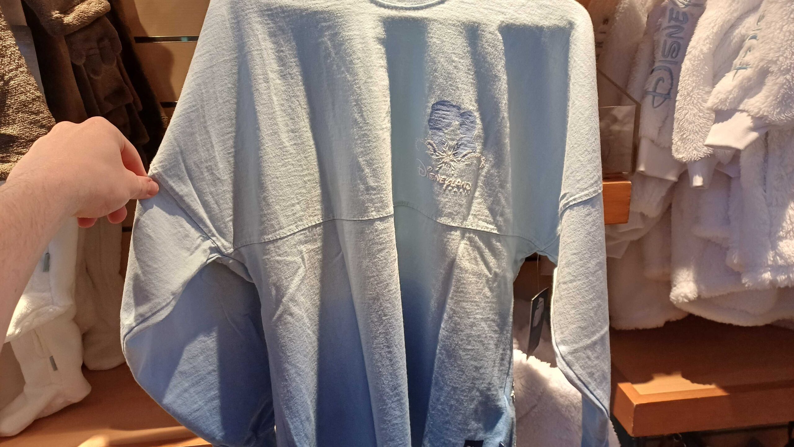On the front is a pair of sihlouettes, Anna and Elsa, touching foreheads above a white snowflake and the Disneyland Paris wordmark.