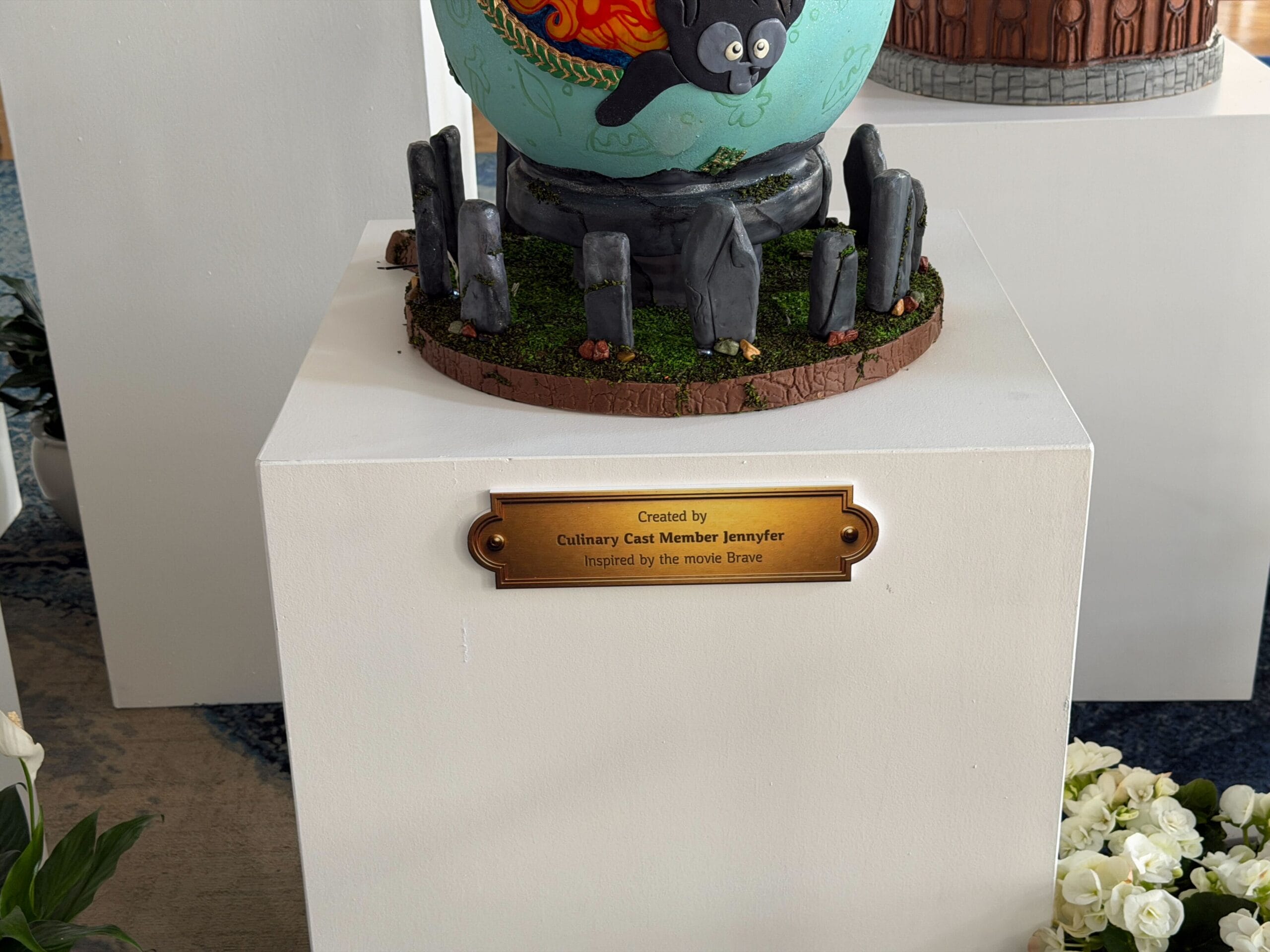 The back of the egg has the family tapestry from the film. The egg is decorated with hidden Mickeys, bows, pudding, and other periphanalia.