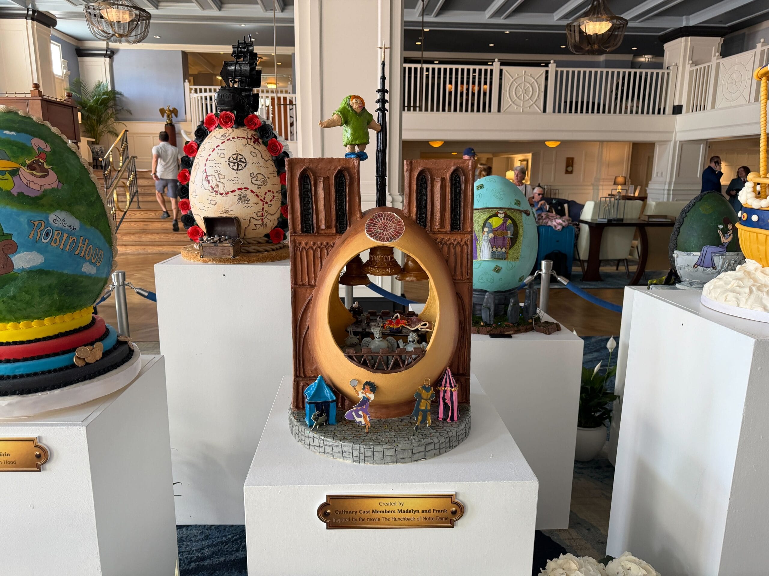 The third display is inspired by the 'Hunchback of Notre Dame'. Notre Dame is represented with its two signature towers, while the egg is the middle part, and hollow. Esmeralda, Captain Phoebus, and her goat are standing on the street, while Quasimodo is T-posing on top of one of the towers.