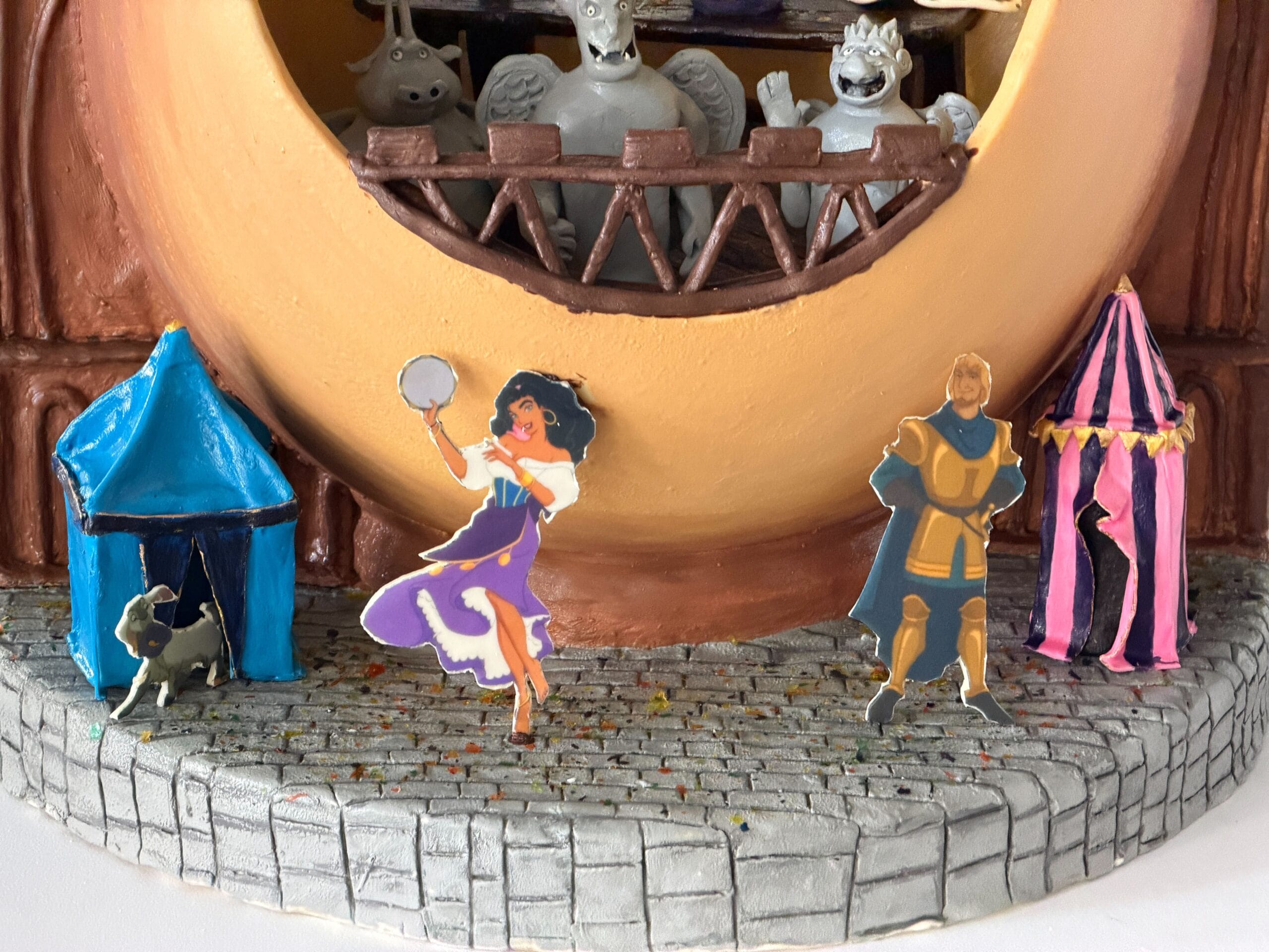 The third display is inspired by the 'Hunchback of Notre Dame'. Notre Dame is represented with its two signature towers, while the egg is the middle part, and hollow. Esmeralda, Captain Phoebus, and her goat are standing on the street, while Quasimodo is T-posing on top of one of the towers.