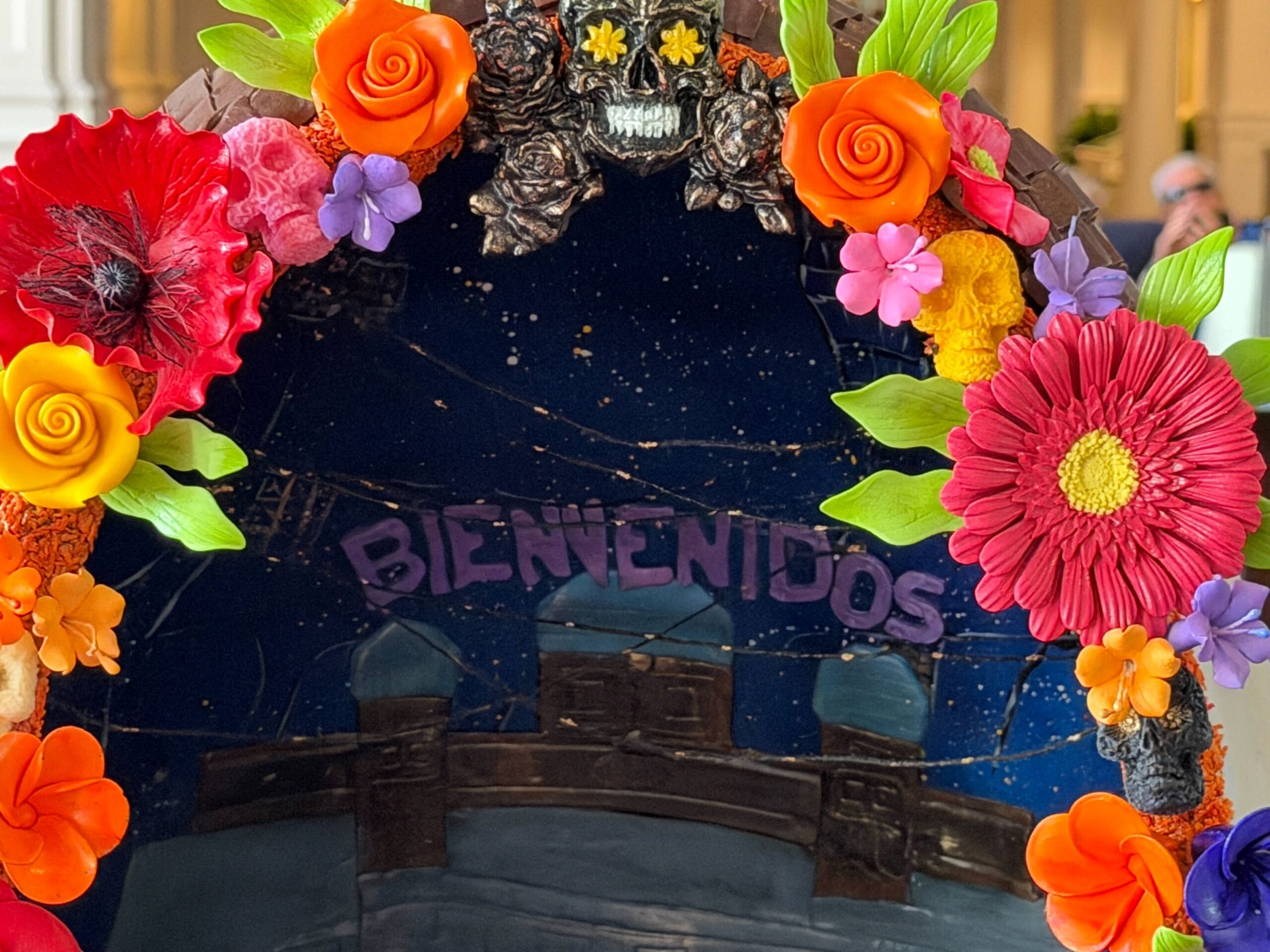 The first egg is inspired by Pixar's 'Coco'. Flowers decorate the hollow interior of the egg as the inside is sculpted to resemble the Marigold Bridge, with the Land of the Dead visible behind it. Bienvenidos is written above the building in purple. The Bridge even has little people crossing it.