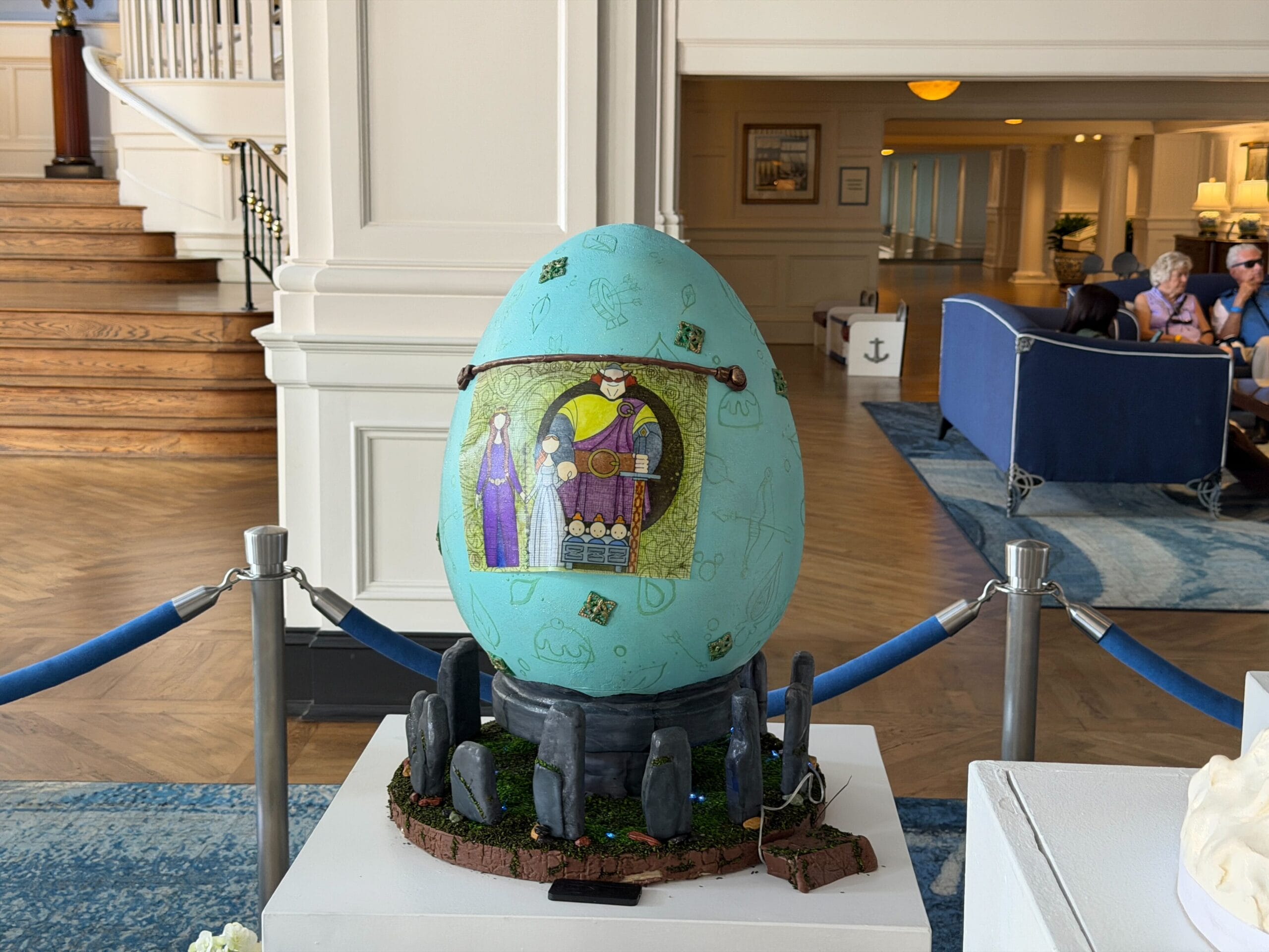 The back of the egg has the family tapestry from the film. The egg is decorated with hidden Mickeys, bows, pudding, and other periphanalia.