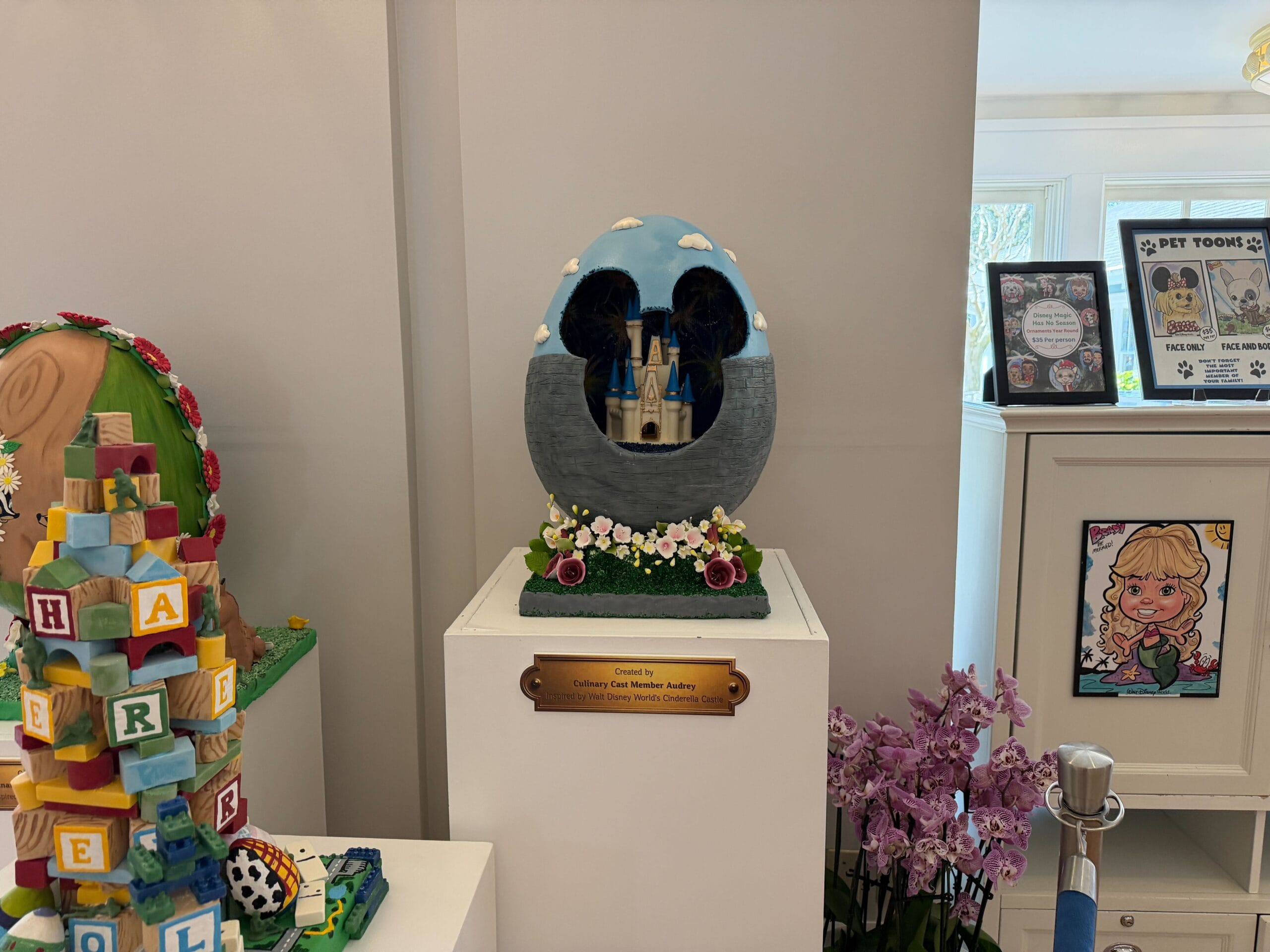 The last of these eggs features Cinderella Castle inside a hollow egg. The bottom half is patterned with bricks, while the top half resembles a sky. Flowers adorn the base. The castle appears to have its old color scheme, which is being slowly restored on the real thing.