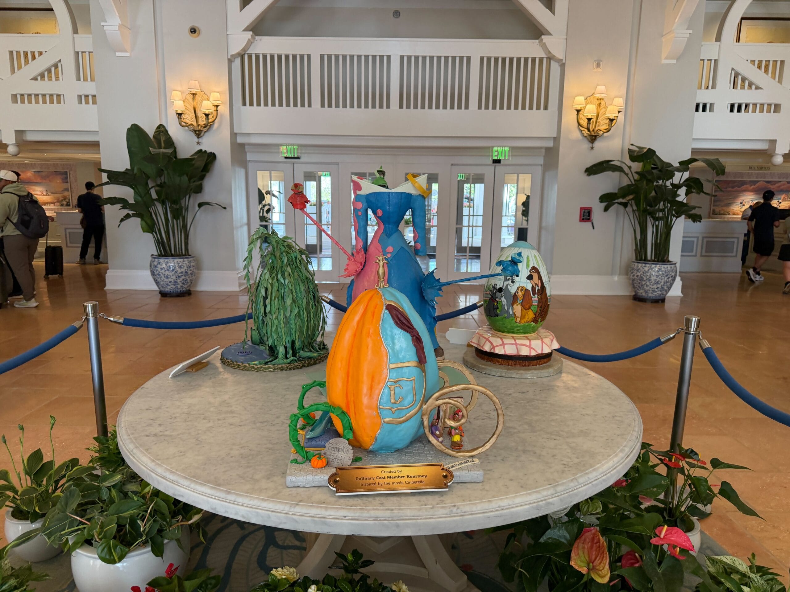 Jaqcues, Gus, and Mary, the mice from the film, as they are reading the book from which they make Cinderella's dress. Bibbity Bobbity Boo! is written on the ground, while another sign reads Pumpkin Patch! next to the glass slipper sitting on a pillow.