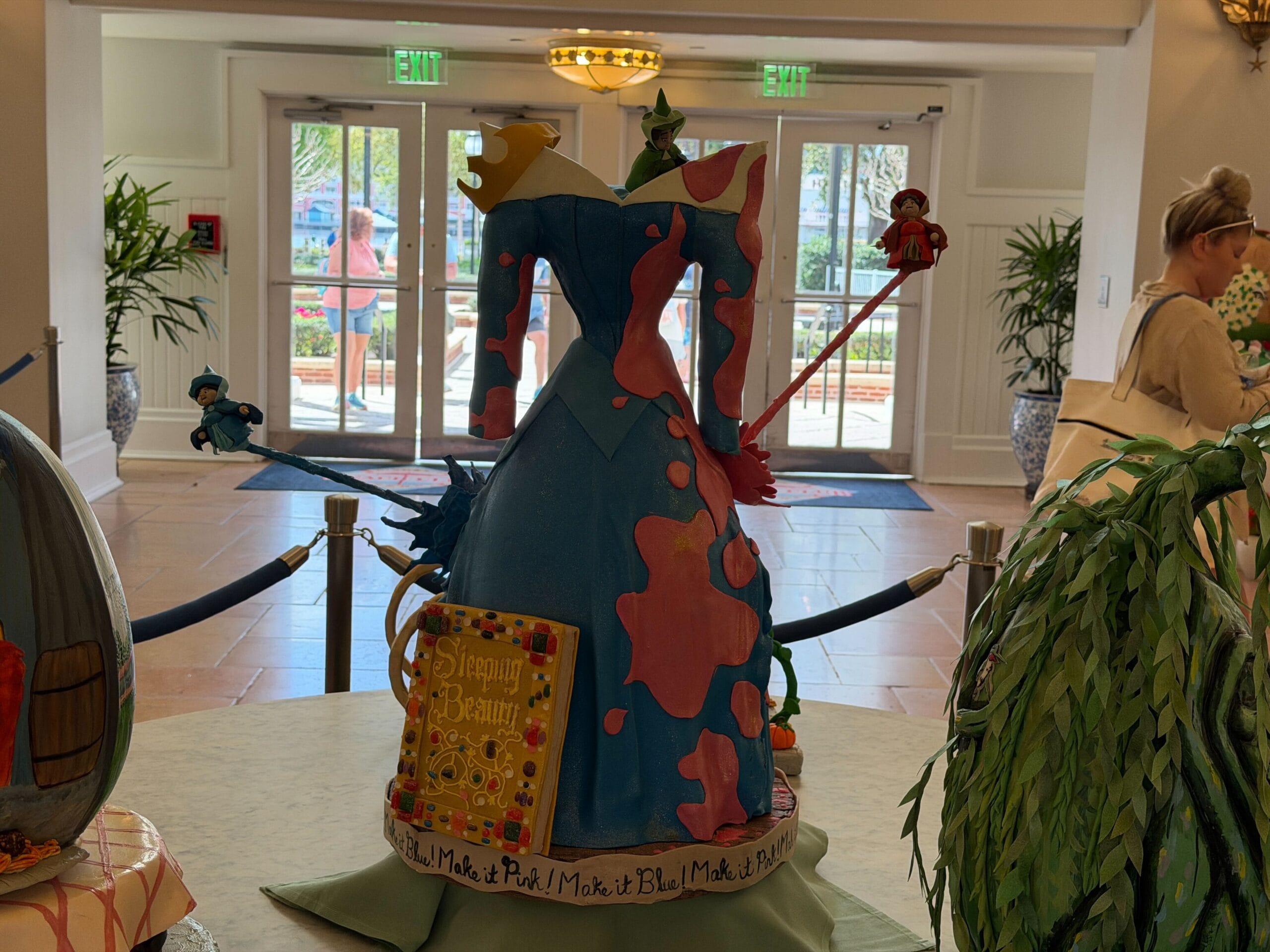 The last egg (if you can call it that) is Aurora's dress from Sleeping Beauty, split unevenly between pink and blue. Make it pink! and Make it blue! is written all around the base, while the storybook leans against the dress.