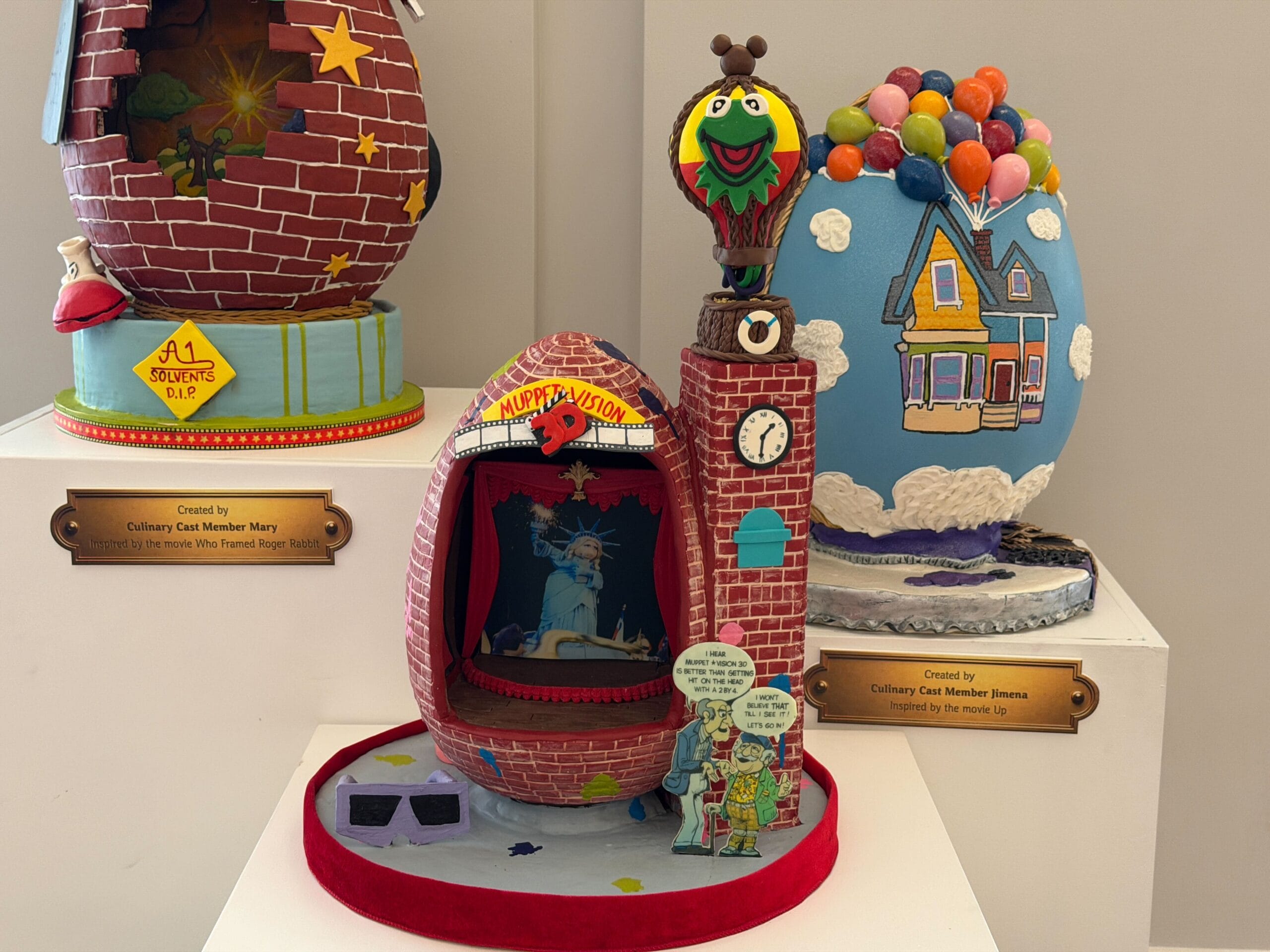 The first egg is inspired by a former attraction, MuppetVision 3-D. The egg is in the shape of the building, complete with the original logo and balloon on top of the clock tower, which was later removed due to sightline issues with Galaxy's Edge. Statler and Waldorf's cut-out which was at the front of the building is present, as are the 3-D glasses.