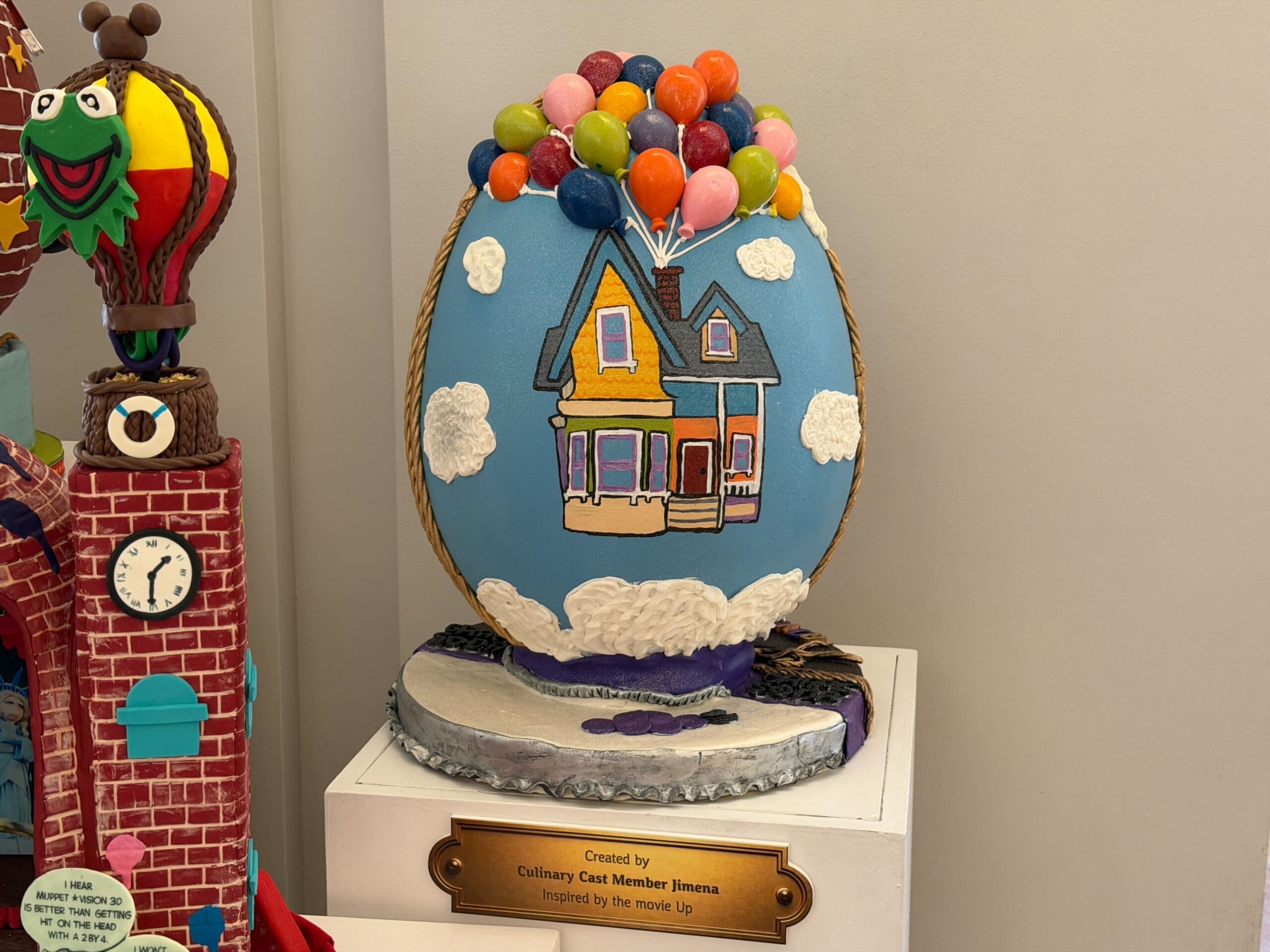 The last of these three is inspired by Pixar's Up. It features a painted picture of the house, while balloons are 3D modeled above it, as are the clouds the house is floating through. The base of the display is partially purple, presumably a reference to the grape soda cap from the film. The way these three eggs are on display makes it difficult to get a good look at the back.