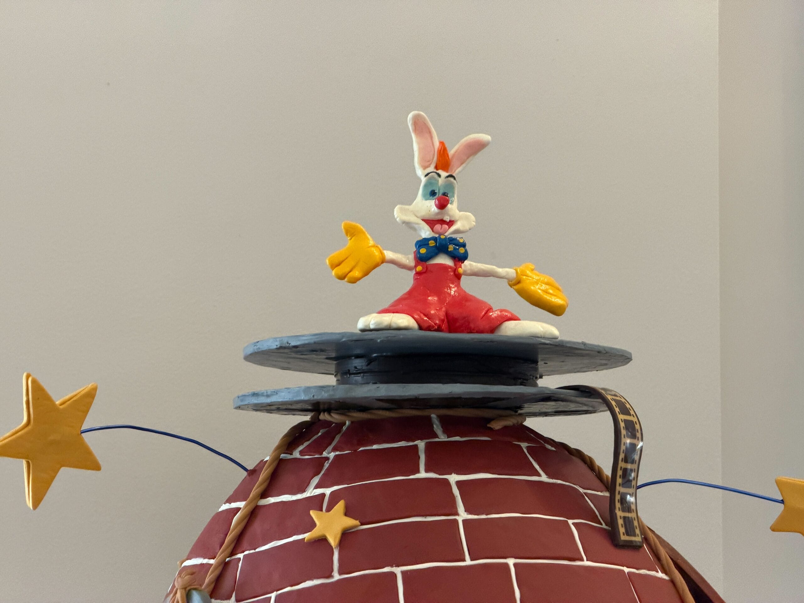 The second egg is inspired by the film Who Framed Roger Rabbit. The egg has a brick pattern, reminiscent of the warehouse in the climax, as through a hole in the wall, Toontown is visible. The dip is dripping from the egg, with a yellow sign that reads 'A1 Solvents D.I.P.' in the middle. The shoe that gets dissolved is present near the bottom.