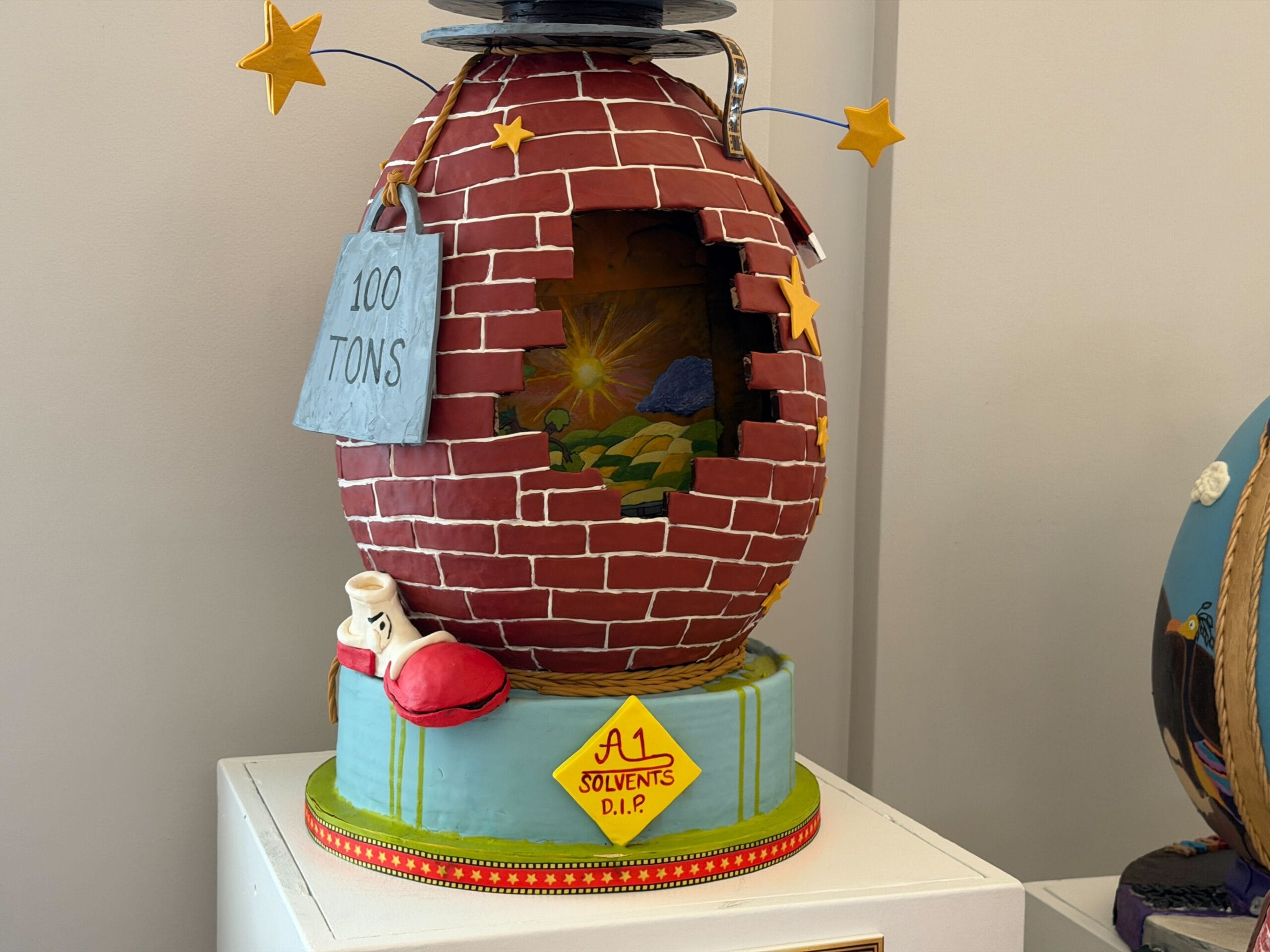 The second egg is inspired by the film Who Framed Roger Rabbit. The egg has a brick pattern, reminiscent of the warehouse in the climax, as through a hole in the wall, Toontown is visible. The dip is dripping from the egg, with a yellow sign that reads 'A1 Solvents D.I.P.' in the middle. The shoe that gets dissolved is present near the bottom.