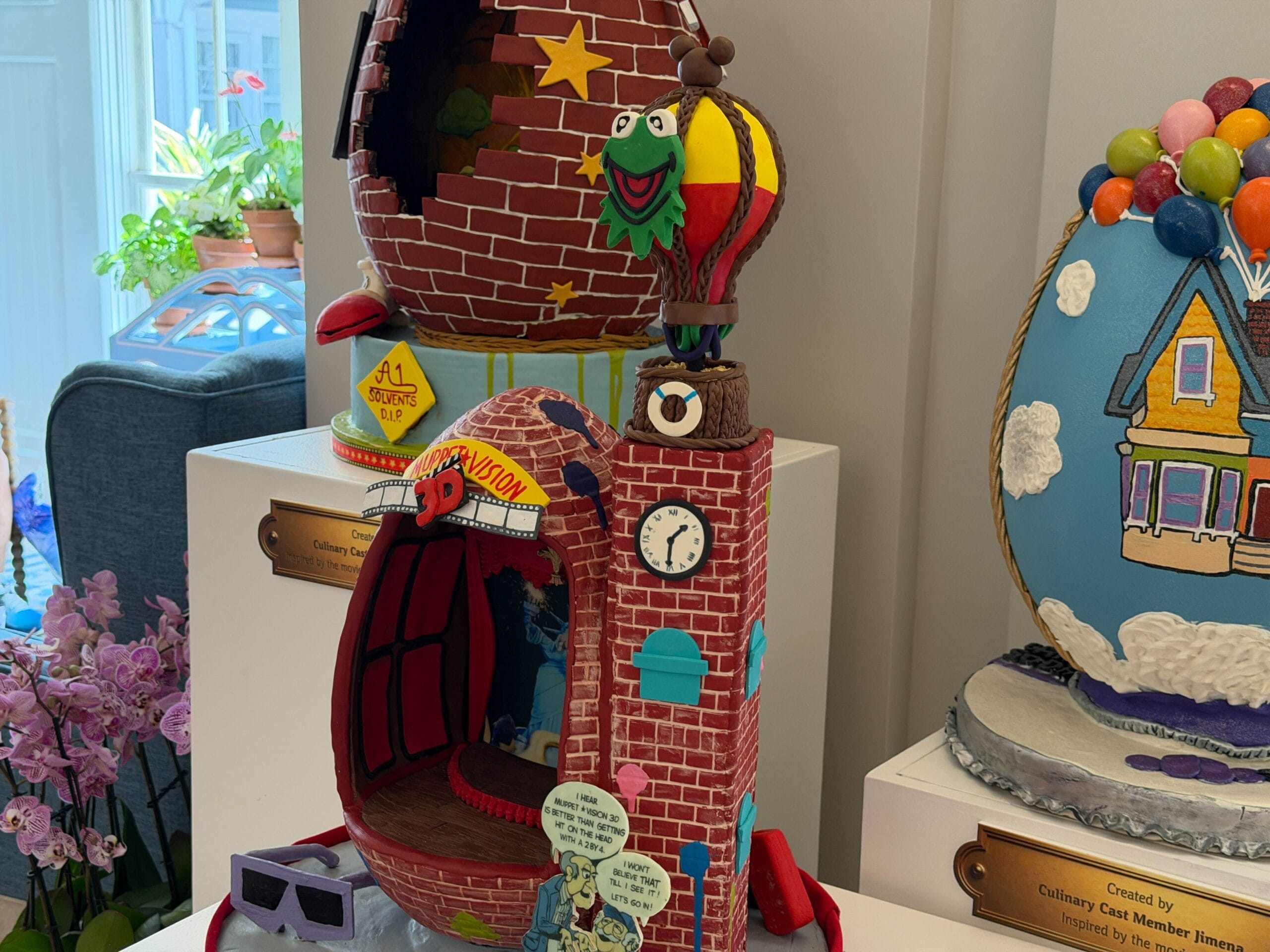 The first egg is inspired by a former attraction, MuppetVision 3-D. The egg is in the shape of the building, complete with the original logo and balloon on top of the clock tower, which was later removed due to sightline issues with Galaxy's Edge. Statler and Waldorf's cut-out which was at the front of the building is present, as are the 3-D glasses.